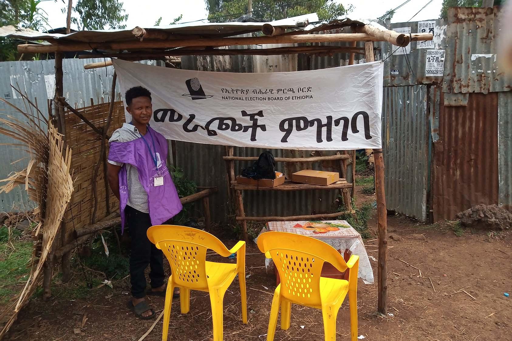 A National Election Board of Ethiopia official waits to register voters outside Bahir Dar, in Ethiopia's Amhara region.