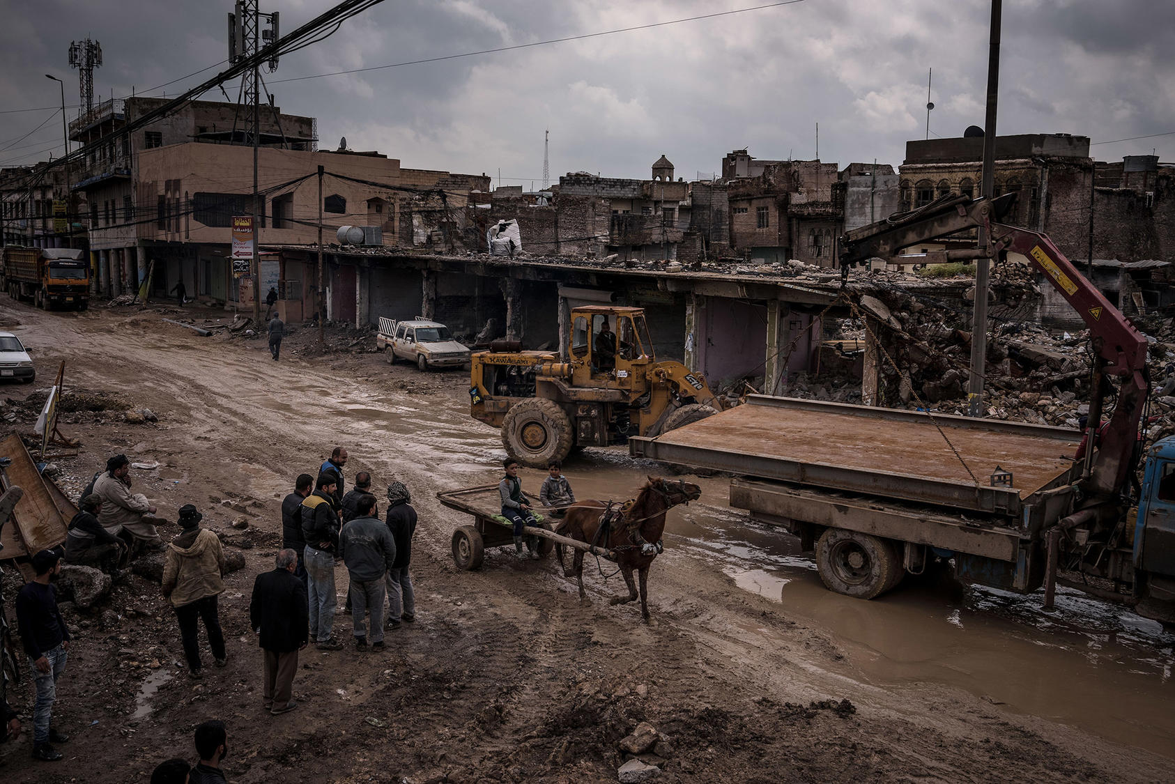 Workers collect the scrap metal from ruined buildings in the Old City of Mosul, Iraq, on March 28, 2019. 