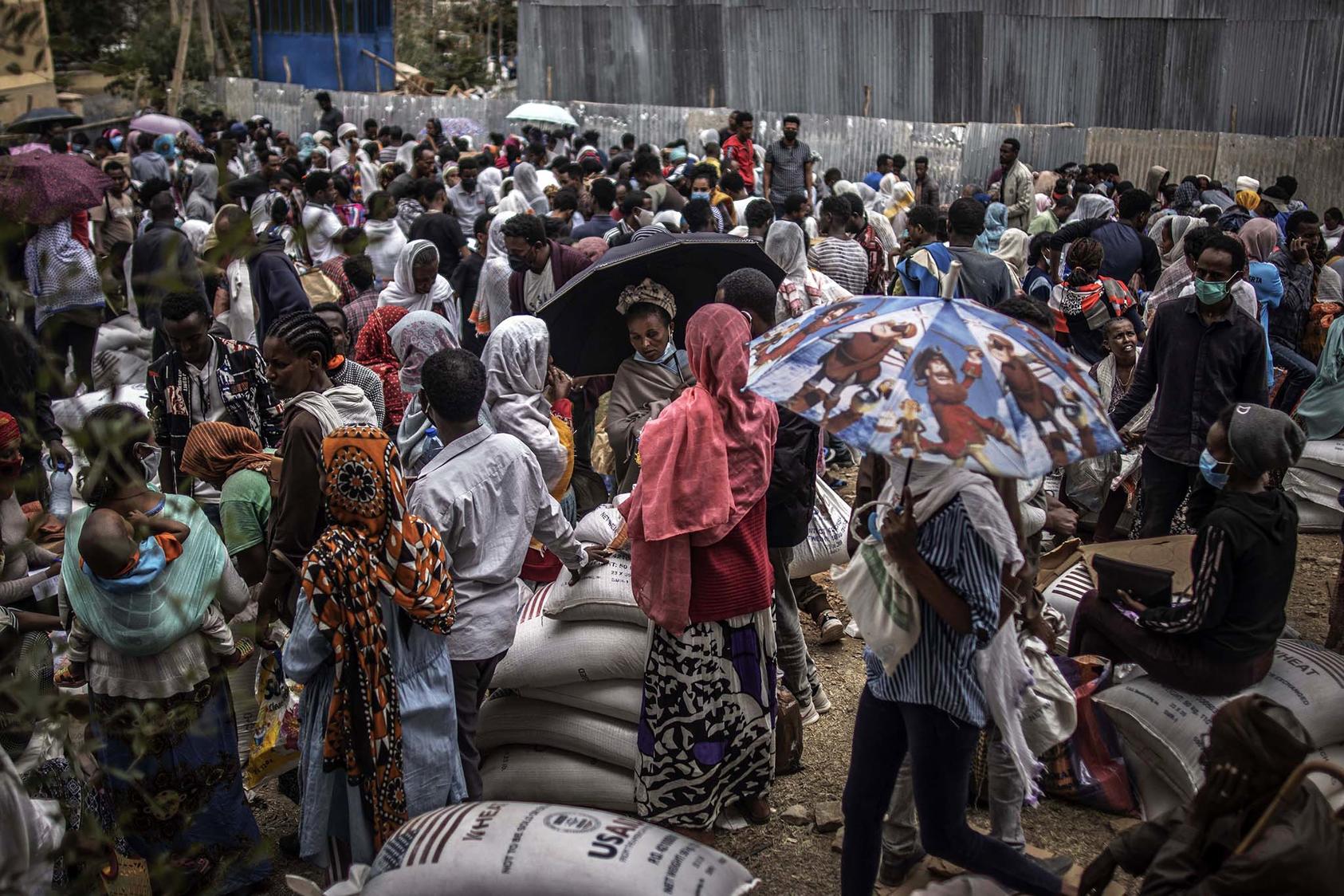 Hundreds of people seek emergency food rations June 26 in Tigray’s capital, Mekelle. To increase food deliveries and prevent starvation deaths among as many as 900,000 people at risk, an effective cease-fire is vital. (Finbarr O'Reilly/The New York Times)