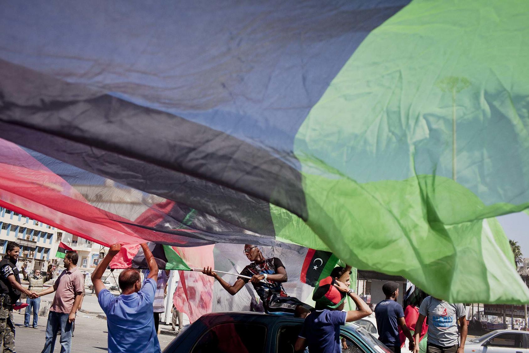 Libyans celebrate in the afternoon during elections in Benghazi, Libya, July 7, 2012. After a decade of conflict, elections slated for December 21 aim to unify the country’s rival administrations and jumpstart national reconciliation. (Tomas Munita/The New York Times)