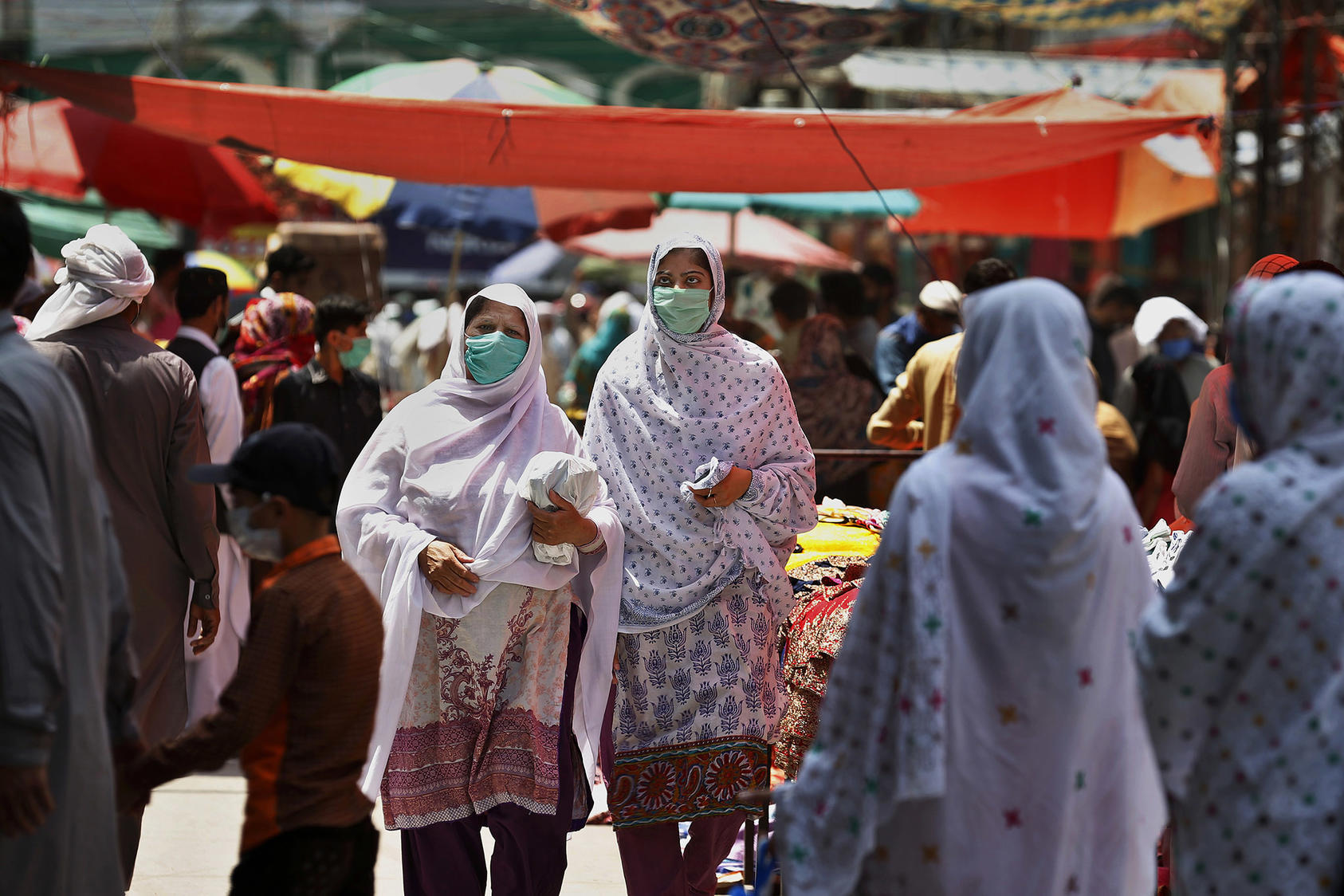 Women wear protective masks while visiting a market in Rawalpindi, Pakistan, on May 9, 2020. (Anjum Naveed/AP)