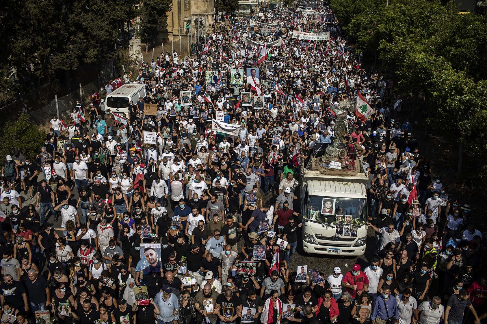 Mourners march in Beirut, Lebanon on Wednesday, Aug. 4, 2021, to commemorate the one-year anniversary of the catastrophic port explosion in Beirut that killed more than 200 people. (Diego Ibarra Sanchez/The New York Times)