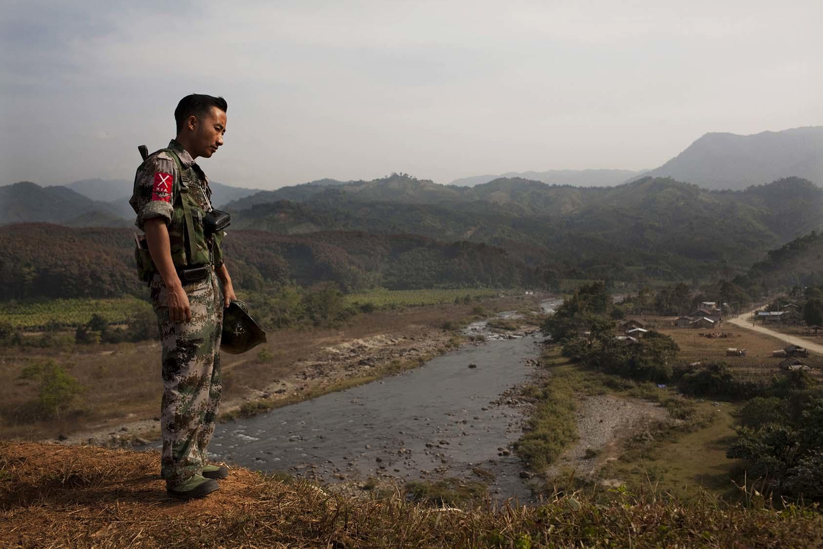 A Kachin Independence Army soldier watches over a river valley separating Myanmar from China on a base near Laiza, Myanmar, Jan. 7, 2012. (Adam Dean/The New York Times)