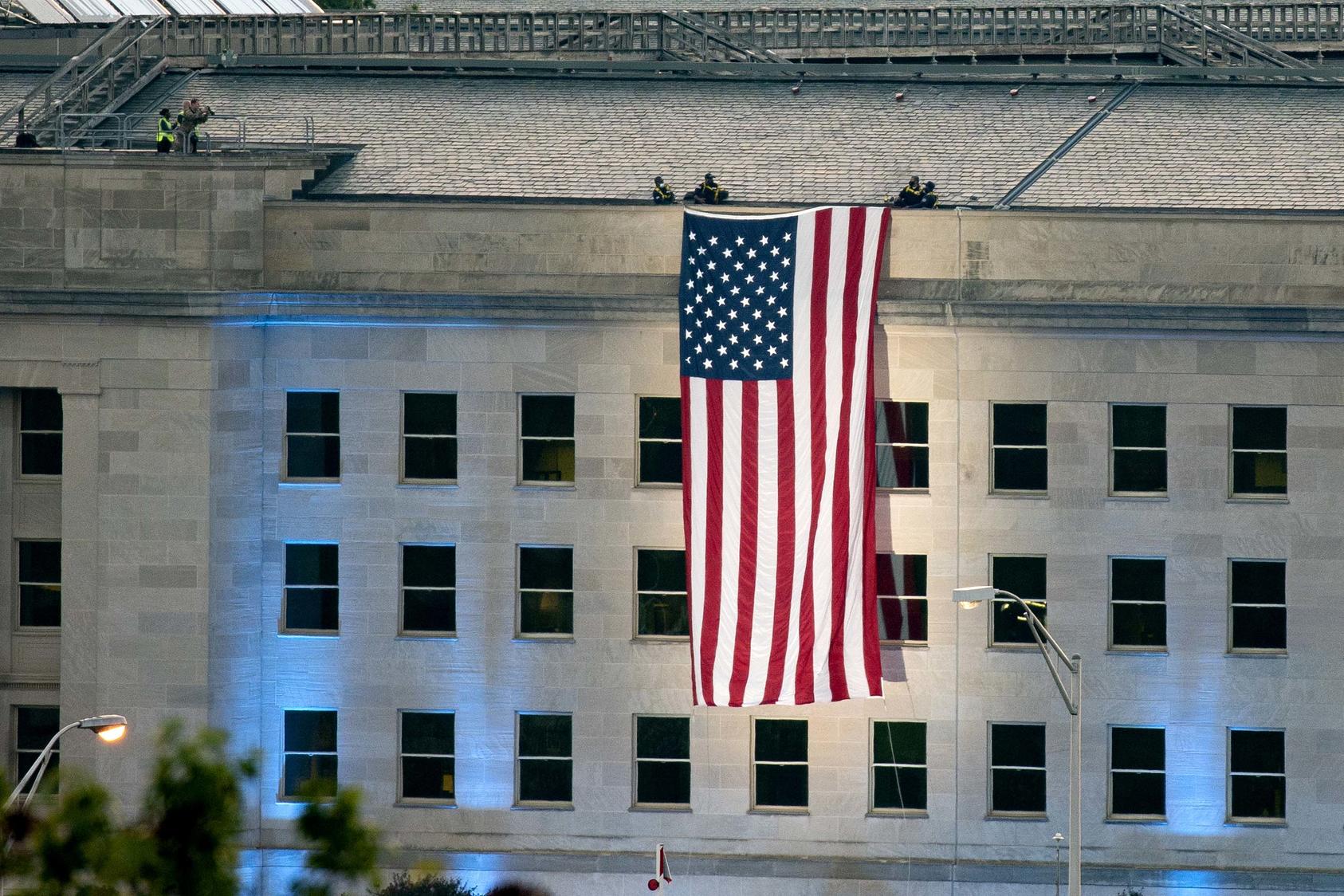 The American flag is unfurled at the site where a hijacked plane crashed into the Pentagon 20 years ago in Arlington, Virginia. September 11, 2021. (Stefani Reynolds/The New York Times)