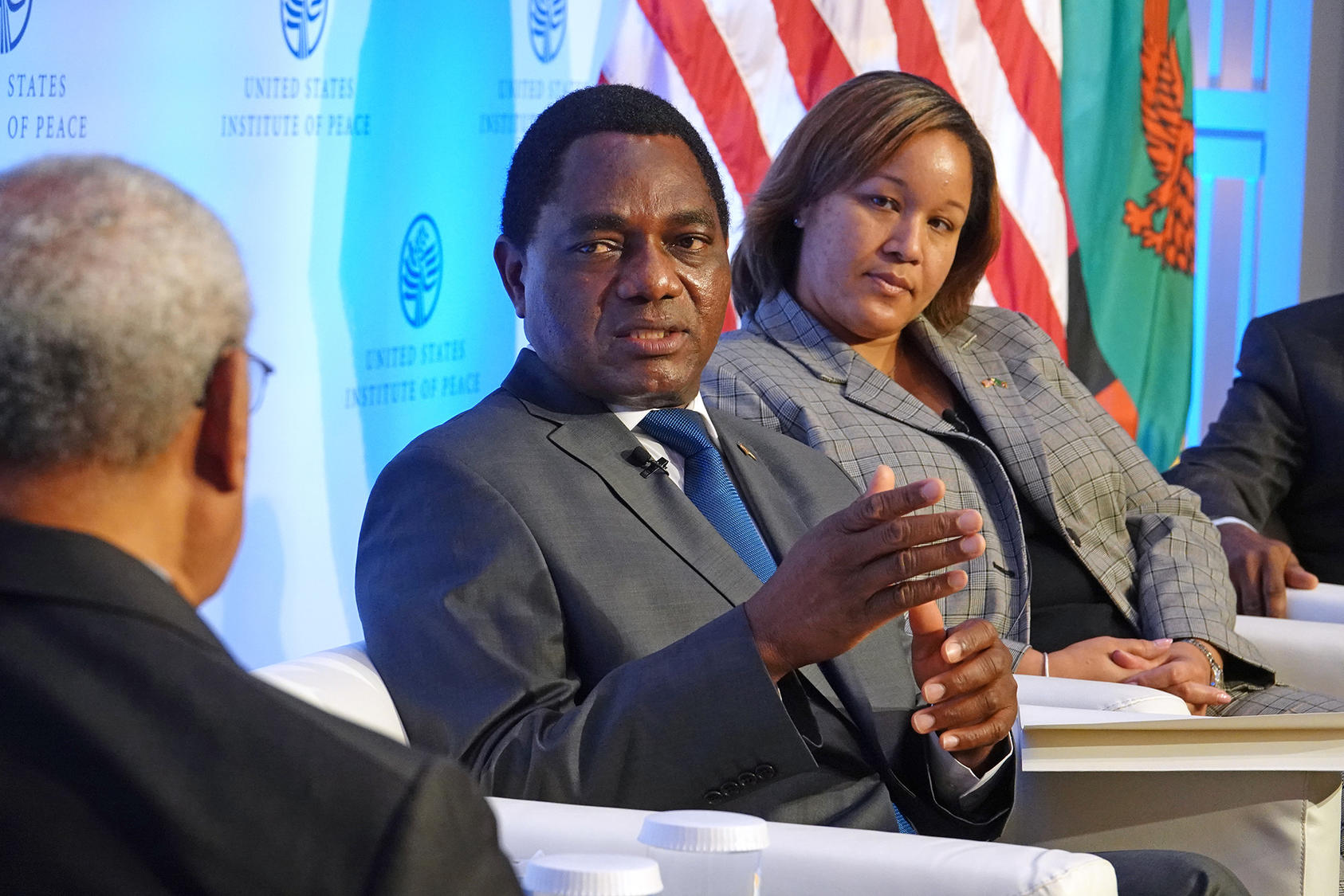 Zambian President Hakainde Hichilema, a business executive elected in his sixth campaign for president, responds to a question from USIP’s vice chair, George Moose. National Security Council Senior director for Africa Dana Banks listens at right.