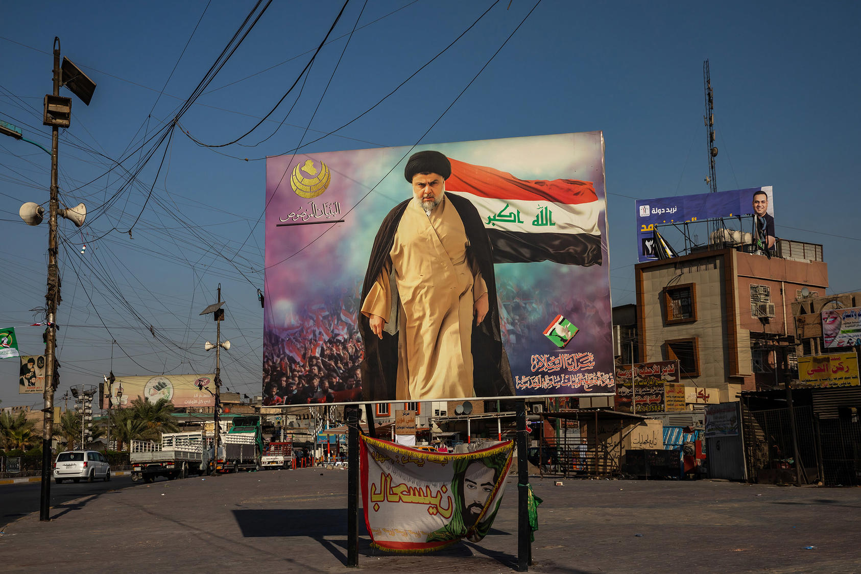 A poster of the Shiite cleric Moktada al-Sadr in the Sadr City neighborhood of Baghdad. September 30, 2021. (Andrea DiCenzo/The New York Times)