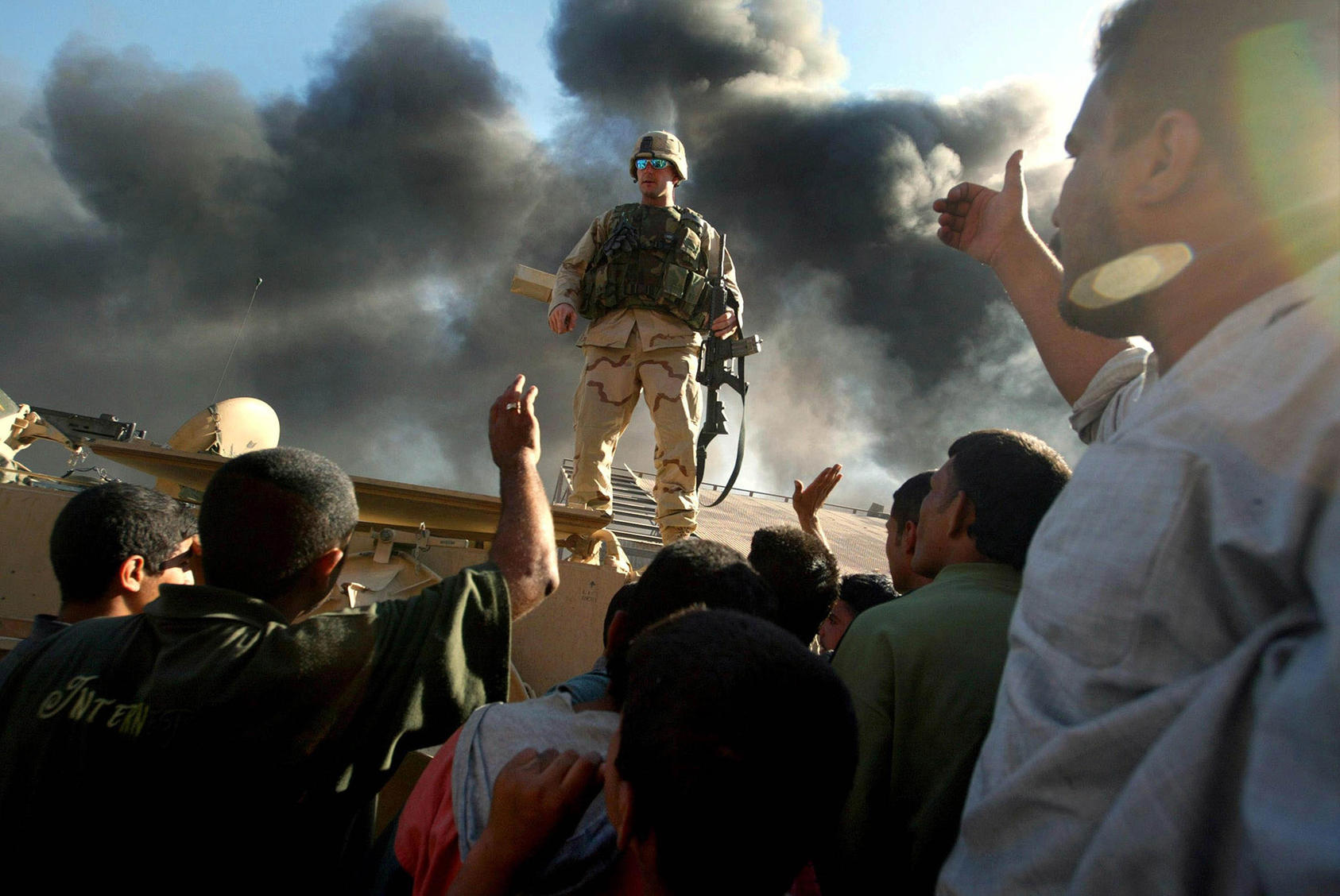 A U.S. soldier confronts angry Iraqi civilians in May 2003 following an explosion in Baghdad. U.S. forces faced severe challenges in trying to govern Iraq after overthrowing Saddam Hussein. (Richard Perry/The New York Times)