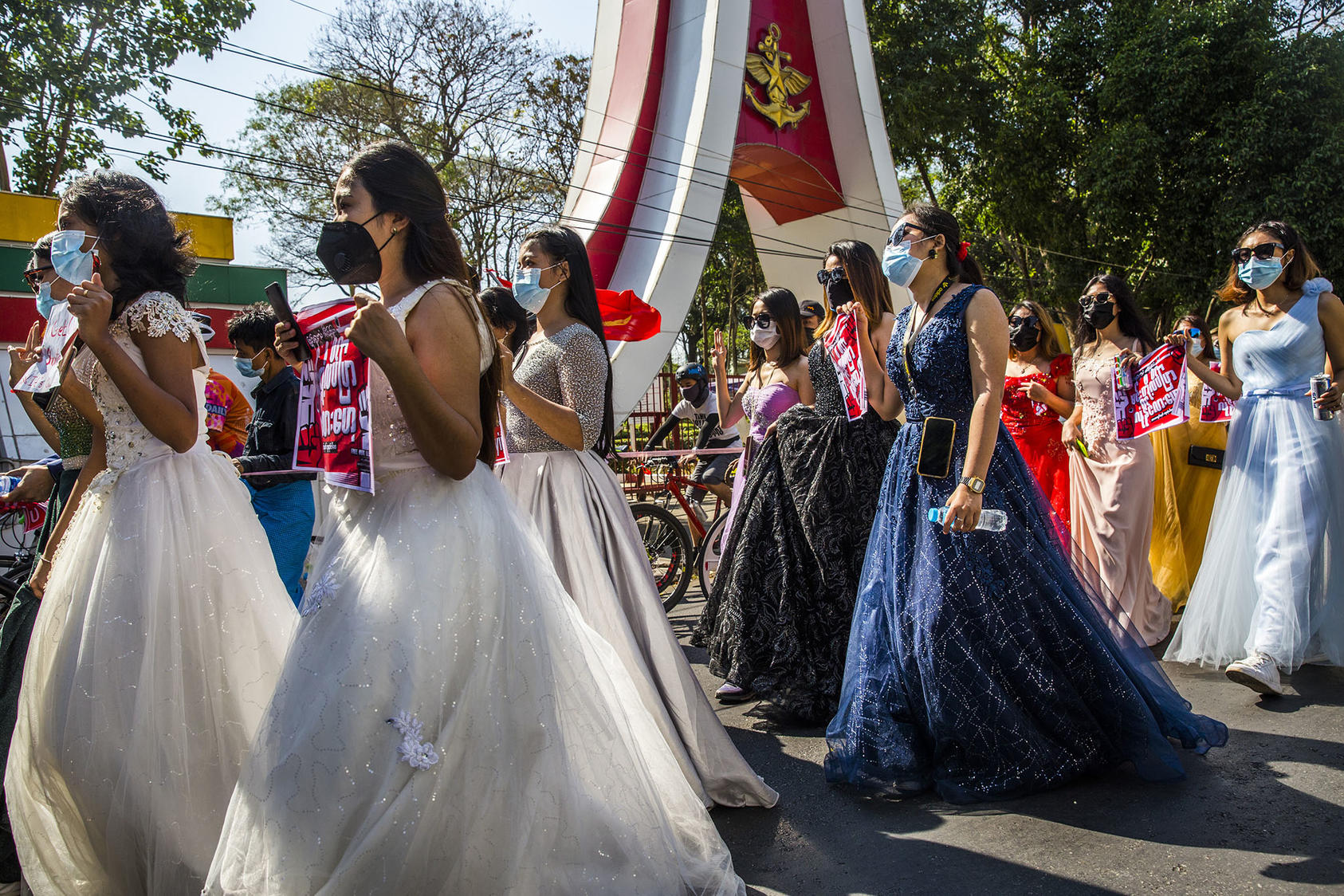 A group of women wearing formal gowns march in Yangon, Myanmar, on Feb. 10, 2021, to protest against the military coup. Despite the danger, women have been at the forefront of the protest movement. (The New York Times)