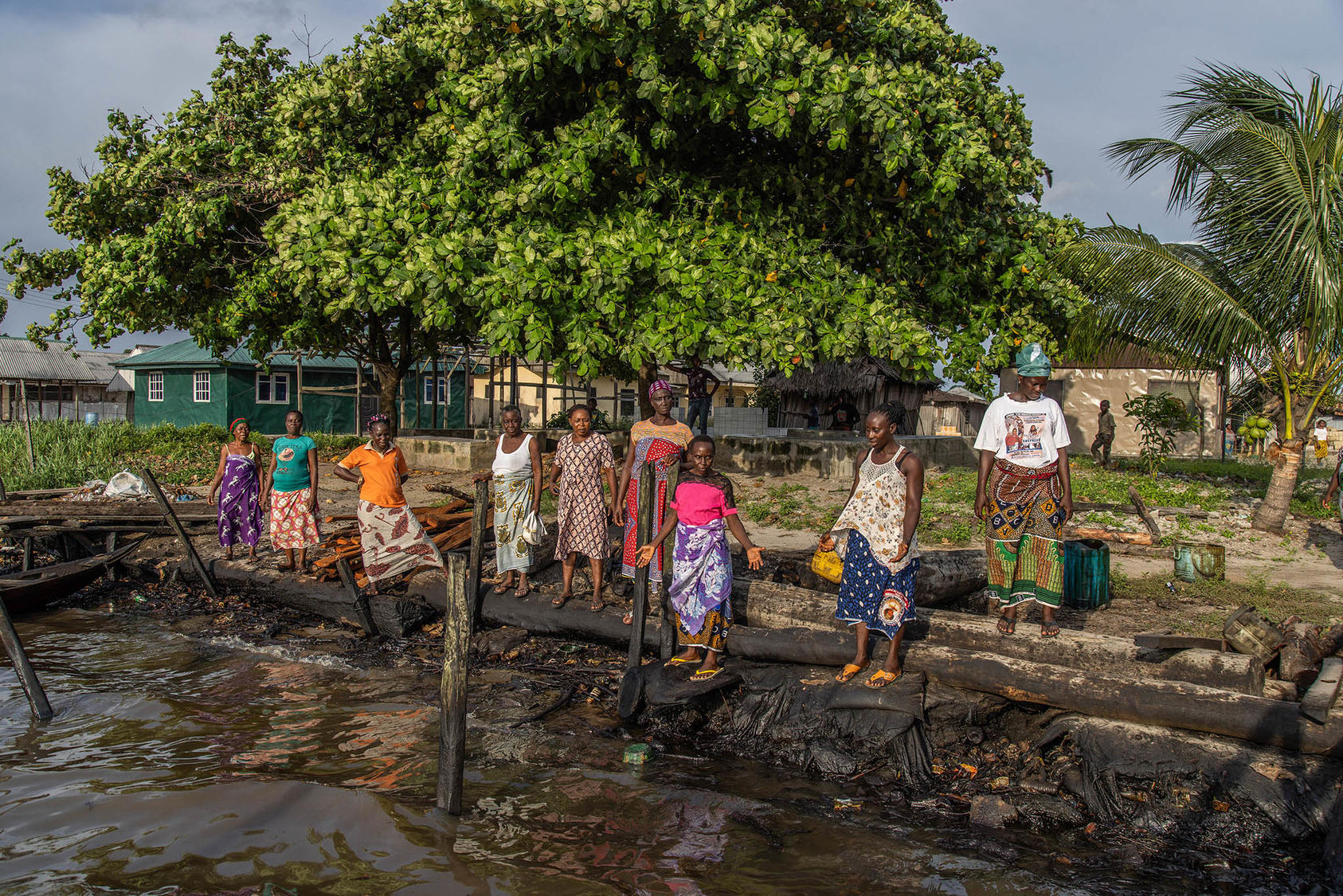 Women in the Niger River delta survey an oil spill in waters that they fish for food. Protests in the delta against the oil industry’s destruction of people’s livelihoods are just one of Nigeria’s many upheavals. (Yagazie Emezi/The New York Times)