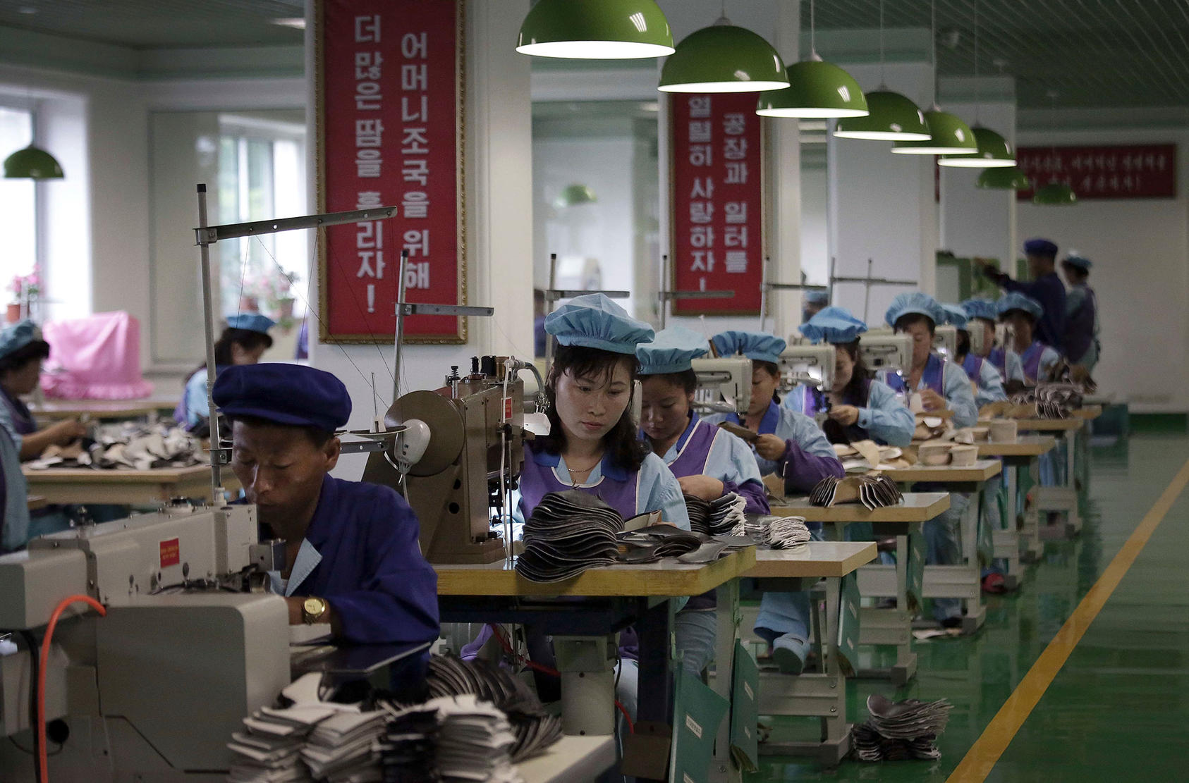 Factory workers operate sewing machines at a shoe factory in Wonsan, North Korea, on June 22, 2016. (Photo by Wong Maye-E/AP)