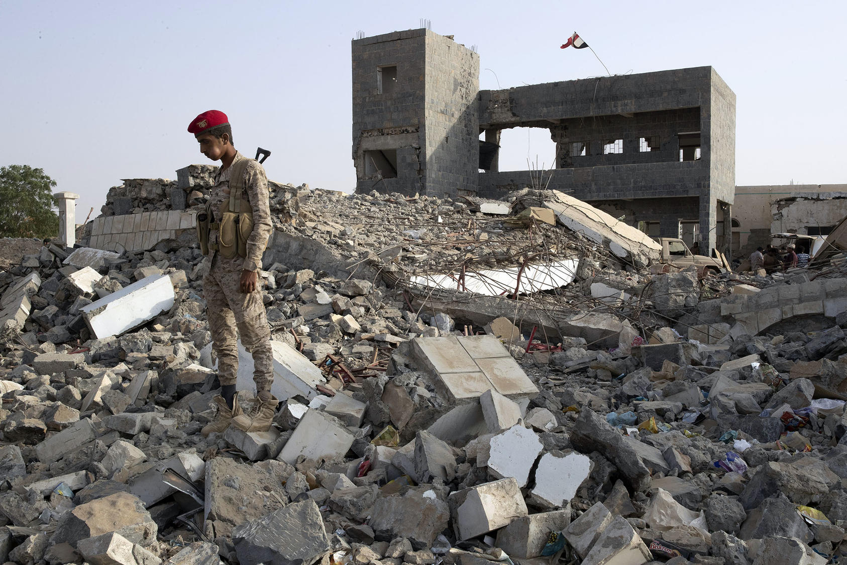 A Yemeni military policeman stands atop the rubble of a former school in the Hairan district of Yemen. January 21, 2019. (Tyler Hicks/The New York Times)