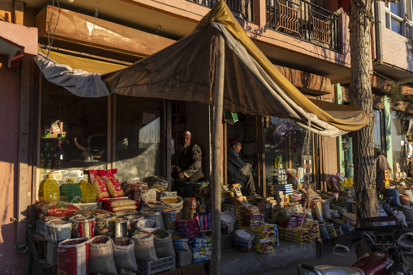 Men sell supplies in Ghazni, Afghanistan, in December 2021. (David Guttenfelder/The New York Times)