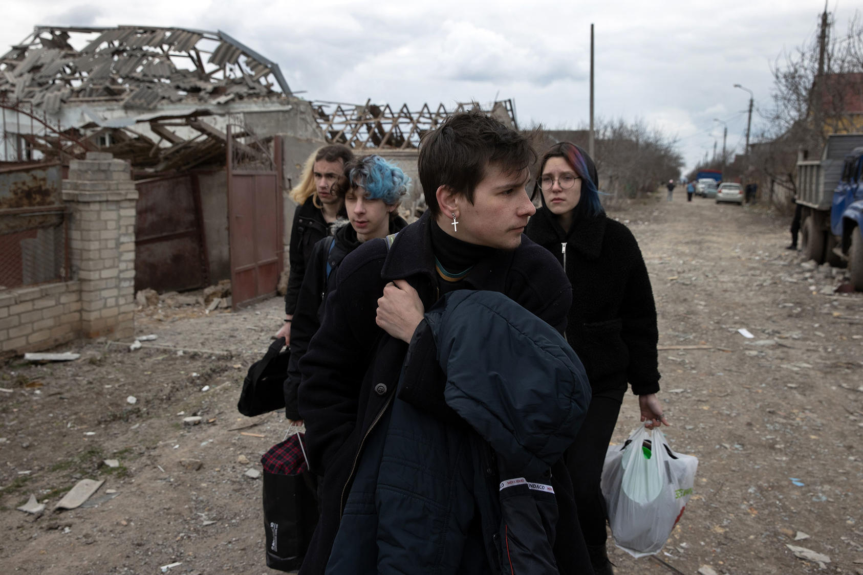 Ukrainians leave home in the village of Ternovka, southern Ukraine, March 8 after it was struck by Russian forces. War crimes investigators are gathering details on the pattern of Russian attacks on civilian targets. (Tyler Hicks/The New York Times)