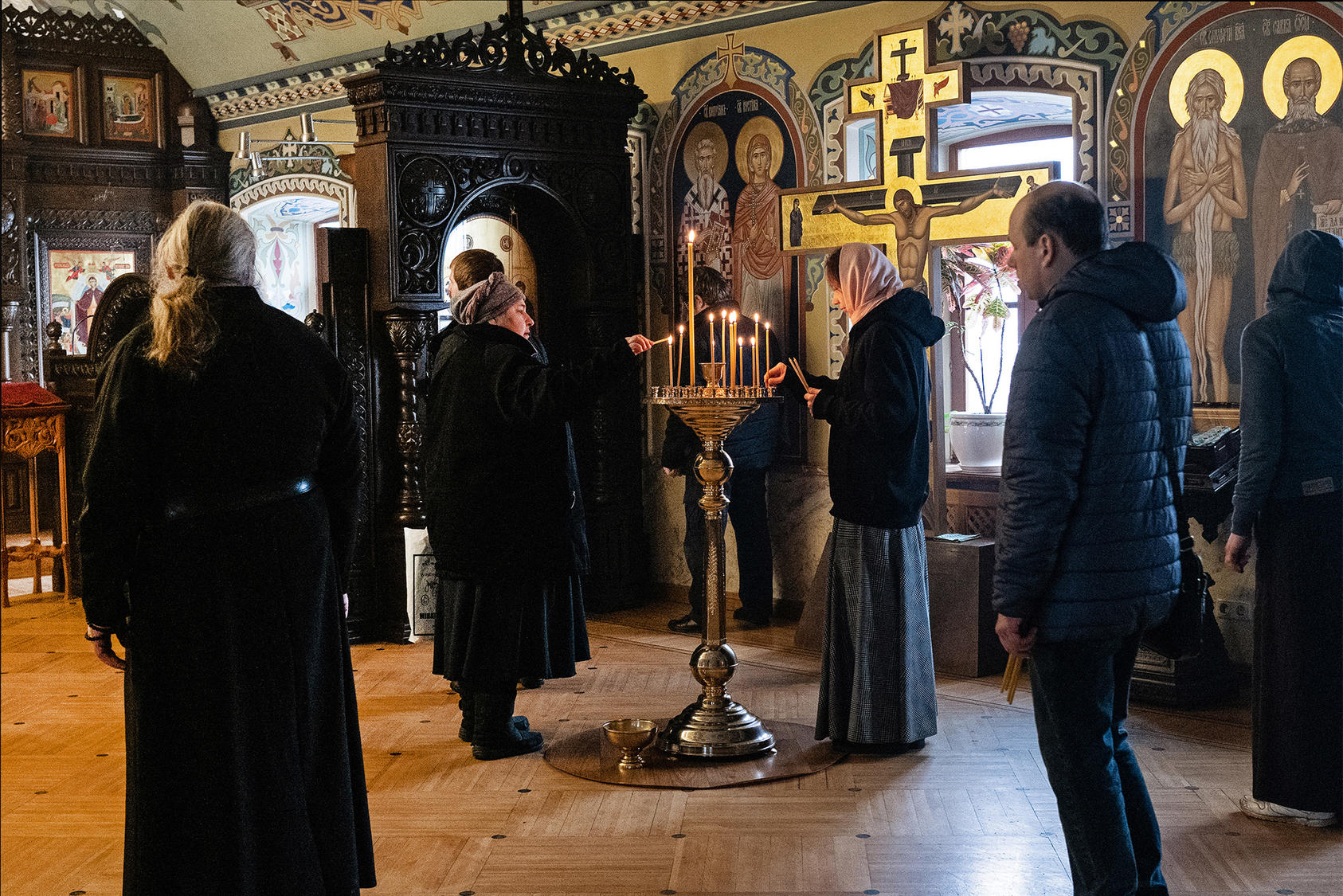 Worshippers light candles at the Monastery of the Caves in Kyiv, one of the holiest sites for Eastern Orthodox Christianity in Ukraine and Russia. March 1, 2022. (Lynsey Addario/The New York Times)