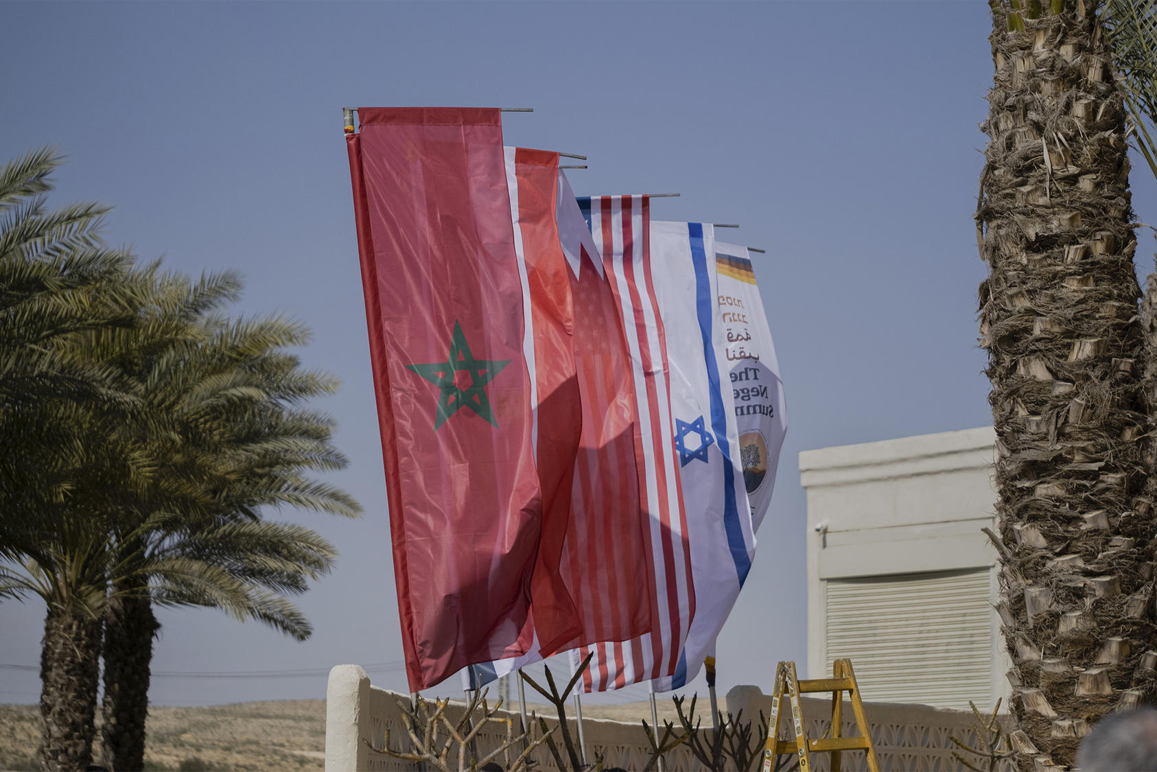 Flags of countries, including Morocco at front, participating in a summit in Sde Boker, Israel. March 27, 2022. (Amit Elkayam/The New York Times)