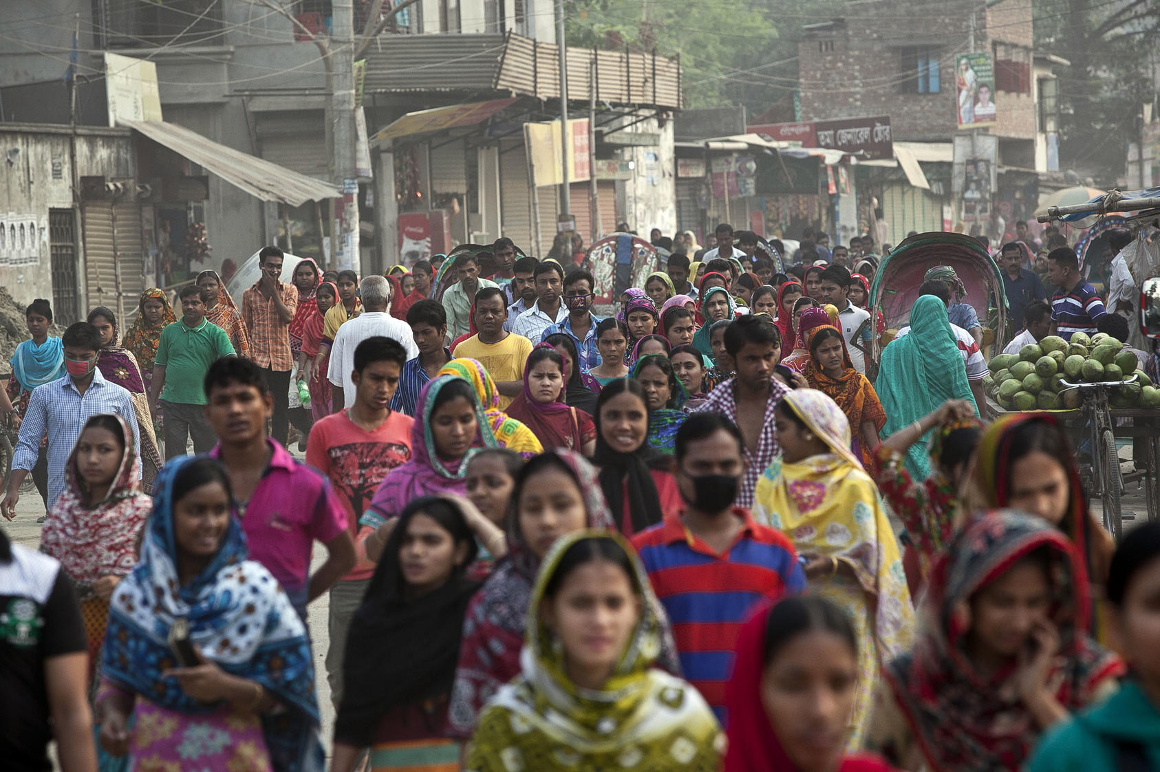 Garment workers walk to their factories in Dhaka, Bangladesh, April 1, 2015. The United States is Bangladesh’s largest export destination, primarily ready-made garments, which is Bangladesh’s main export and lifeline of foreign currency. (Allison Joyce/The New York Times)