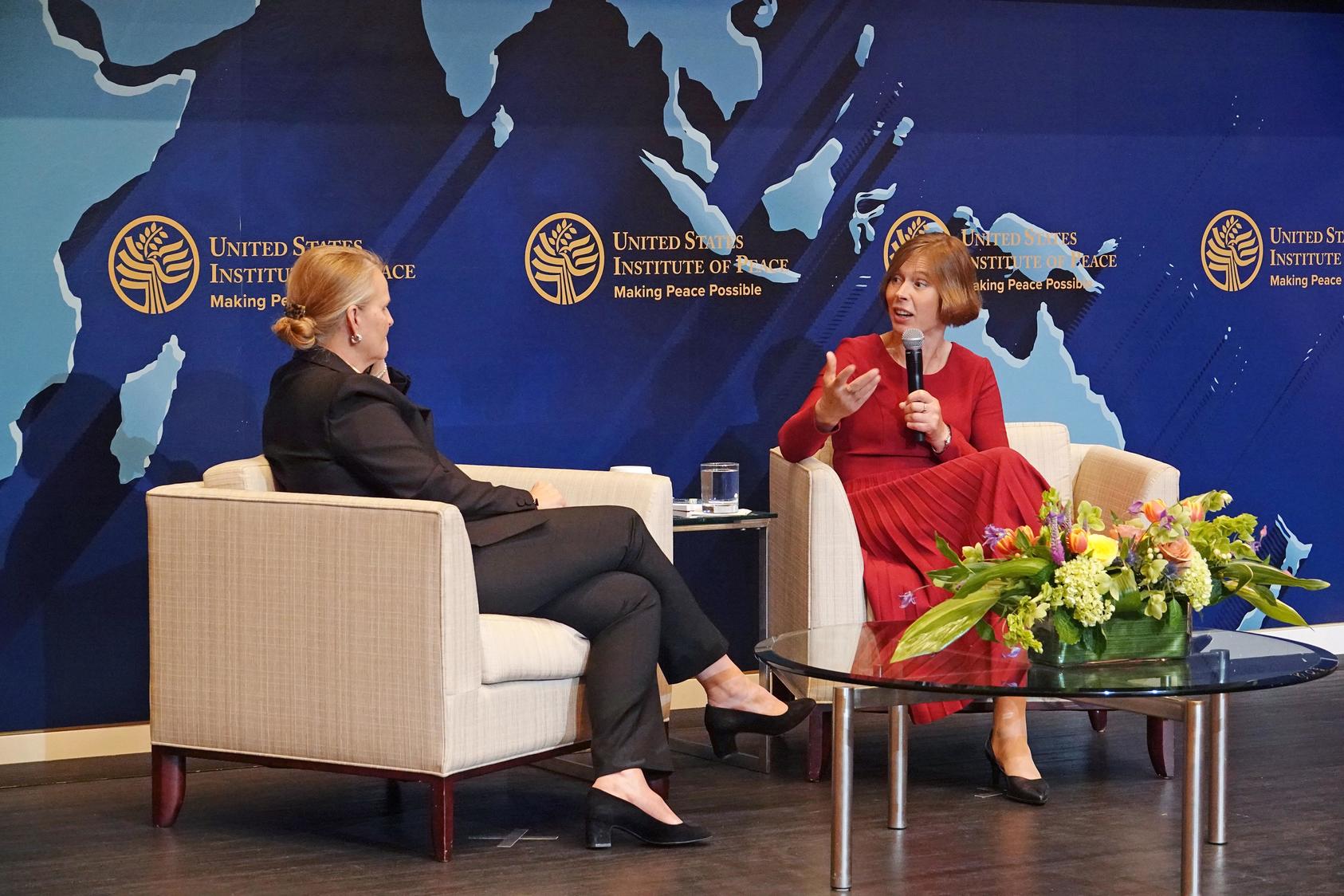 Kersti Kaljulaid, a former president of Estonia, and President of USIP Lise Grande sit facing each other on stage.