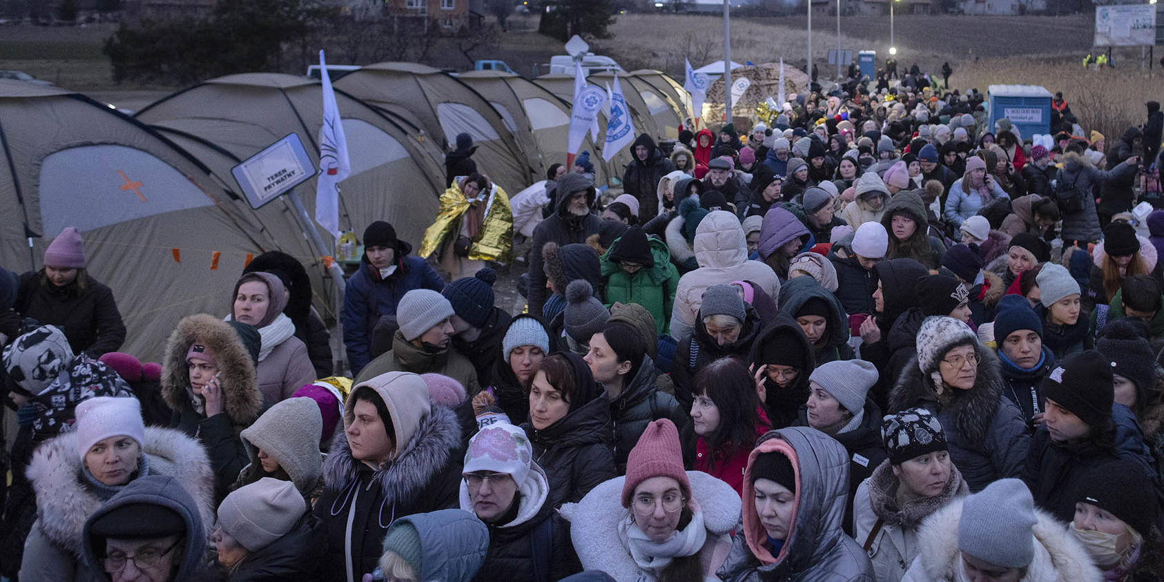 Refugees from Ukraine wait for a bus after crossing the Polish border to Medyka, on March 7, 2022. The humanitarian crisis caused by Russia’s war in Ukraine is rapidly turning into a human trafficking one in which women and children. (Maciek Nabrdalik/The New York Times)