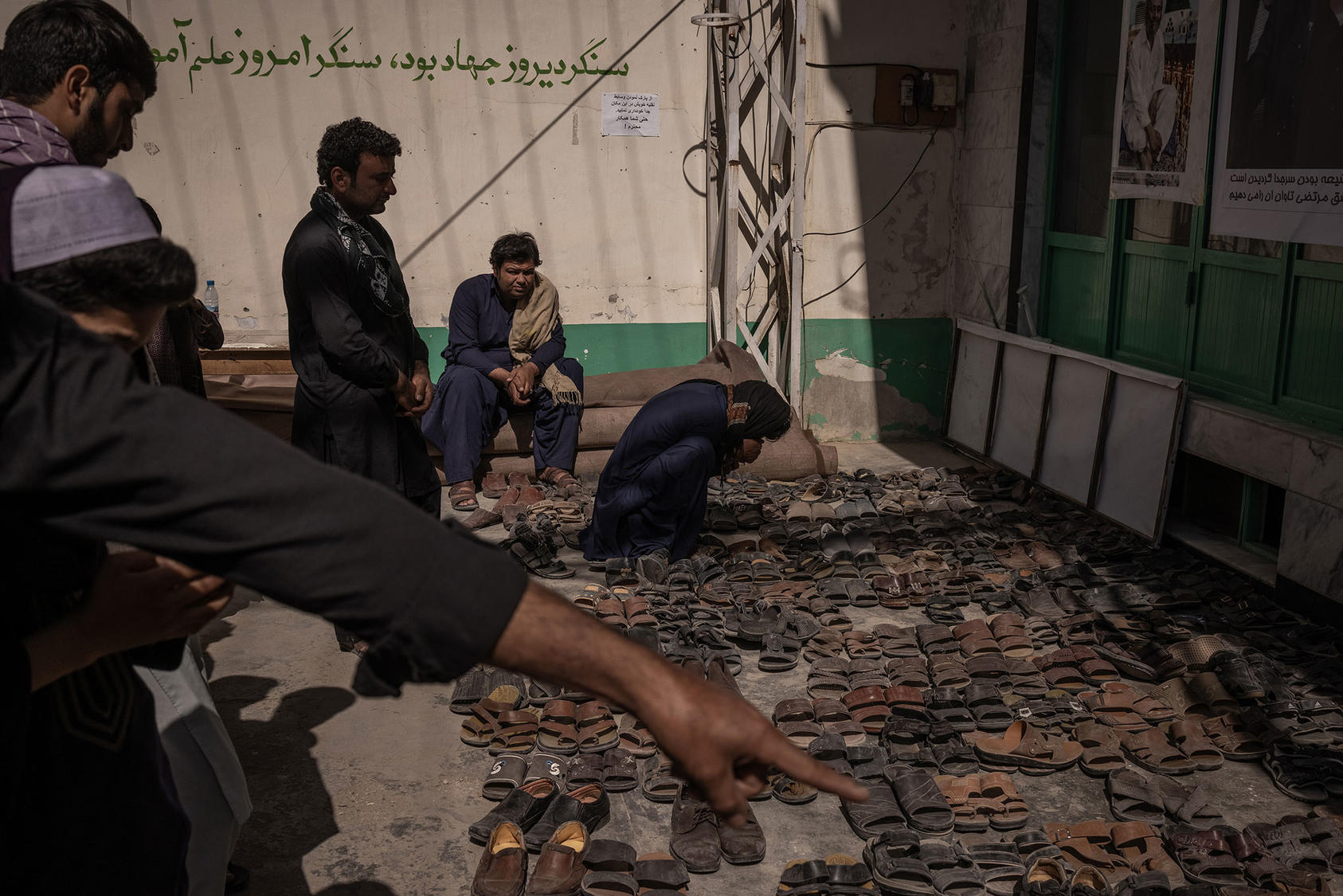 A man grieves at the Bibi Fatima Mosque, where many died in a suicide bombing, in Kandahar, Afghanistan, Oct. 18, 2021.  (Jim Huylebroek/The New York Times)