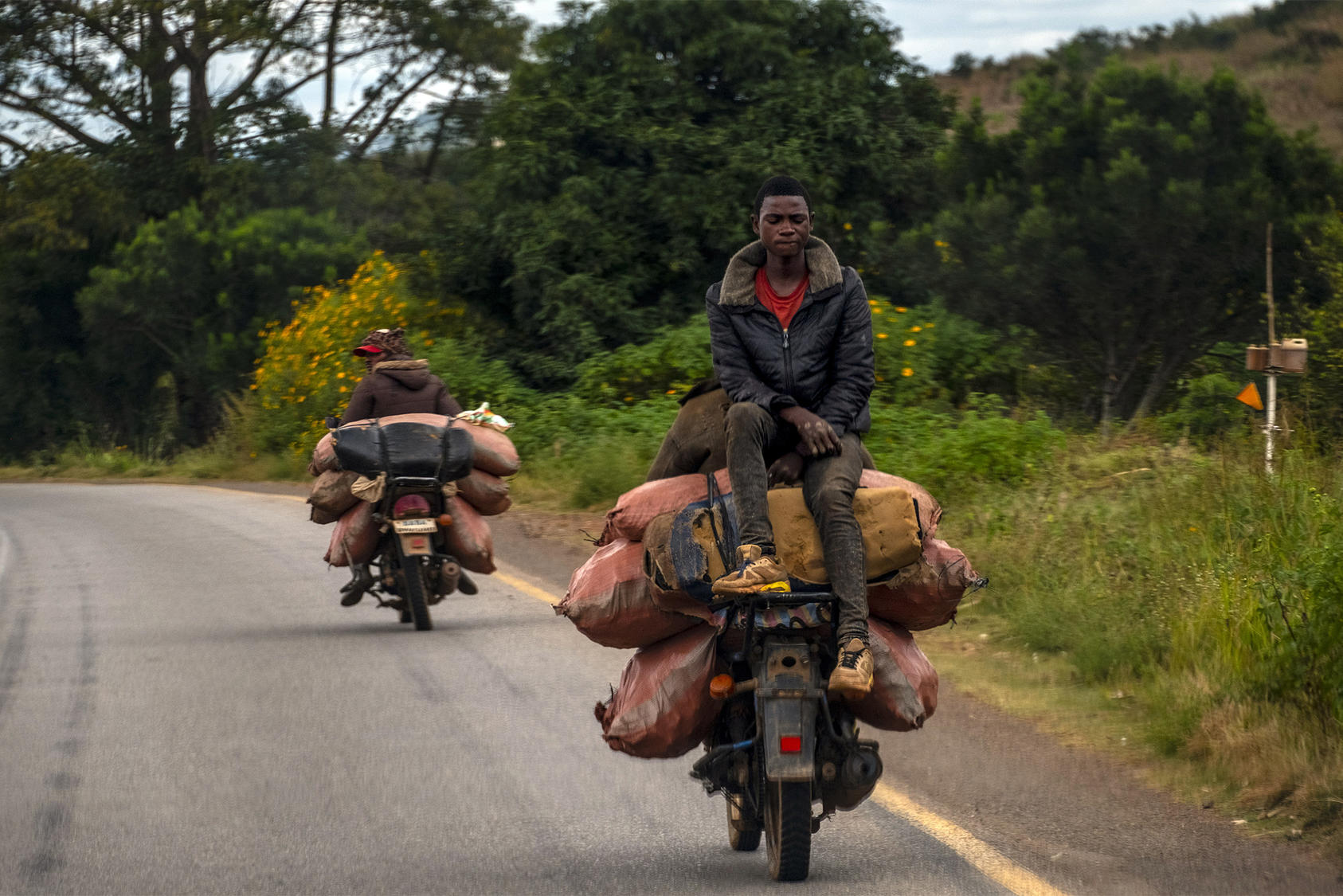 Motorcycles haul cobalt ore, vital to “green” industries such as electric vehicles, from a mine in the Democratic Republic of Congo. Development of Africa’s economy can dilute the influence of authoritarian powers. (Ashley Gilbertson/The New York Times)