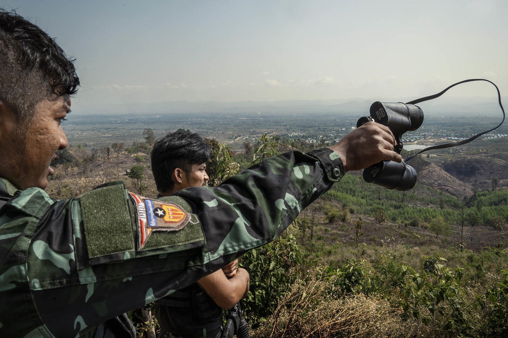 Rebel fighters of the People’s Defense Forces survey government military positions in Kayin State, Myanmar, March 2022. China has chosen to bolster Myanmar’s military fighting a growing popular resistance movement. (Adam Dean/The New York Times)