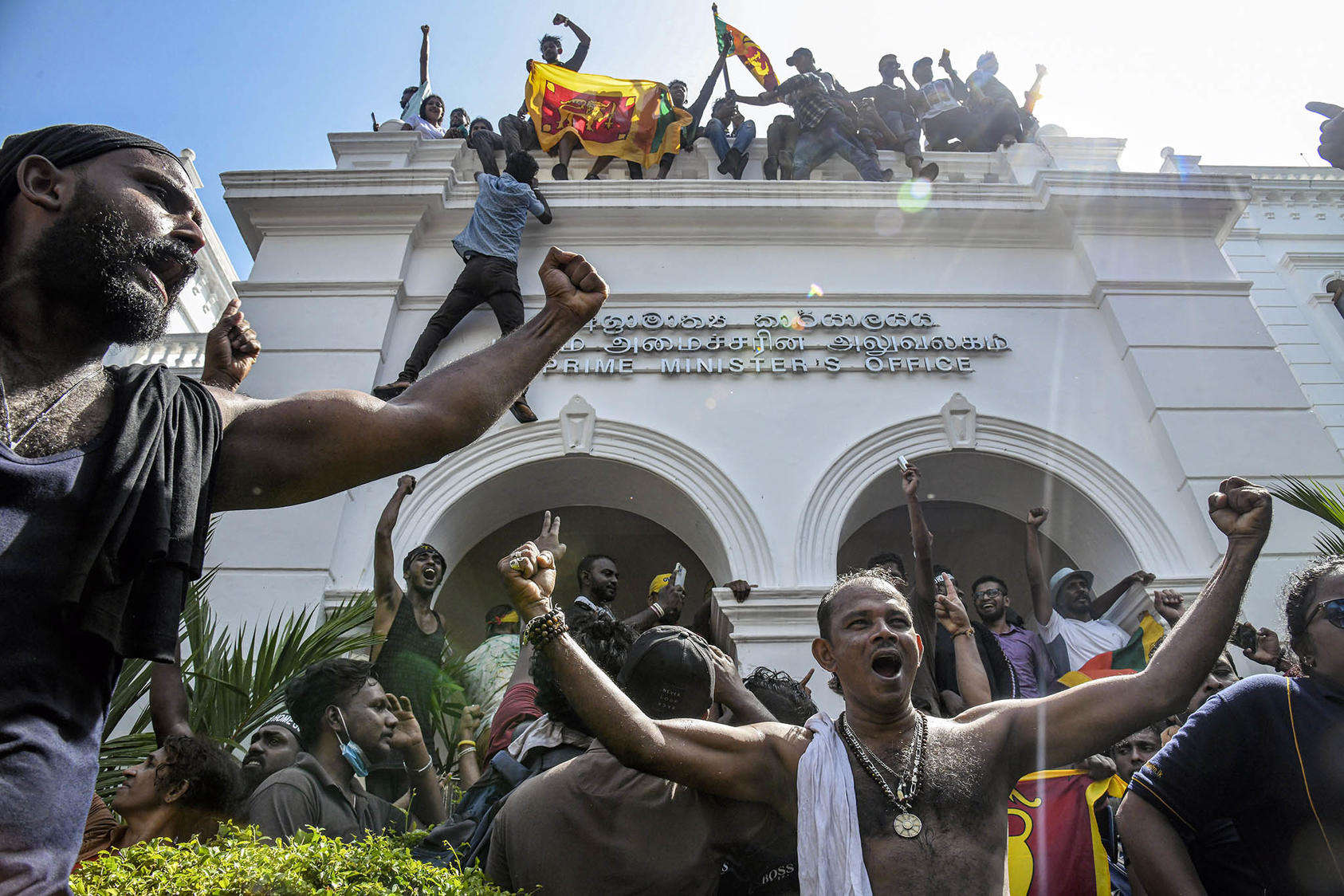 Protesters celebrate after taking over the prime minister’s office in Colombo, Sri Lanka, on July 13, 2022. (Atul Loke/The New York Times)