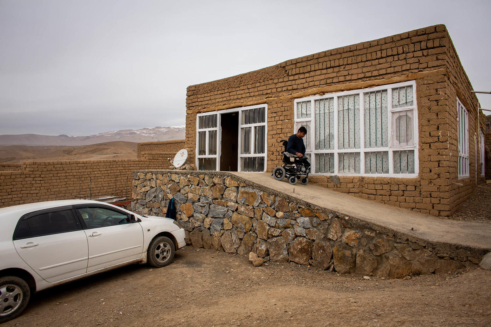 Mirza Hussain Haidari, who lost his legs fighting for the Afghan army, at his home in Bamian, Afghanistan, Nov. 19, 2019. (Jim Huylebroek/The New York Times)