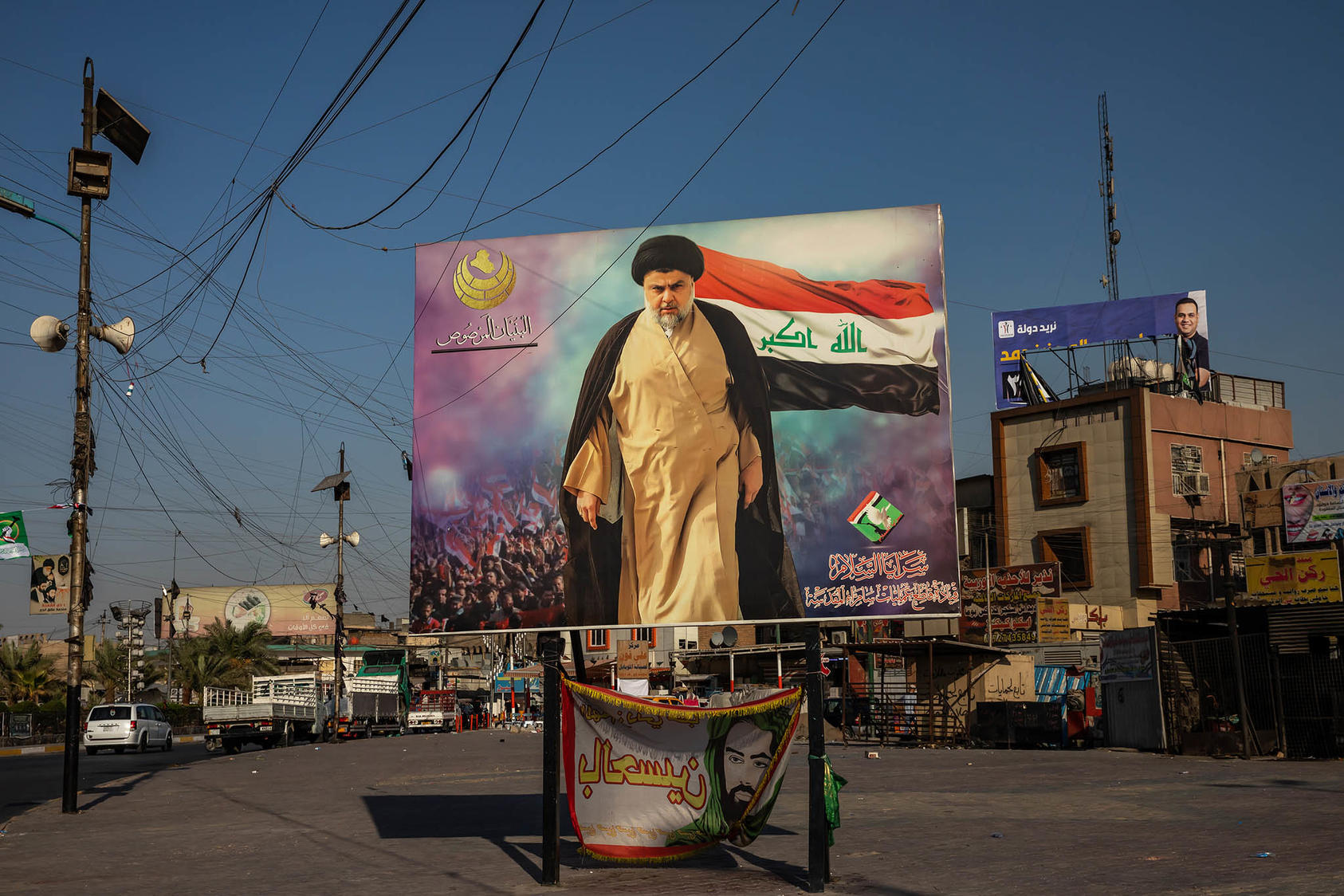 A poster of Shia cleric Moqtada al-Sadr in the Sadr City neighborhood of Baghdad, Sept. 30, 2021. (Andrea DiCenzo/The New York Times)