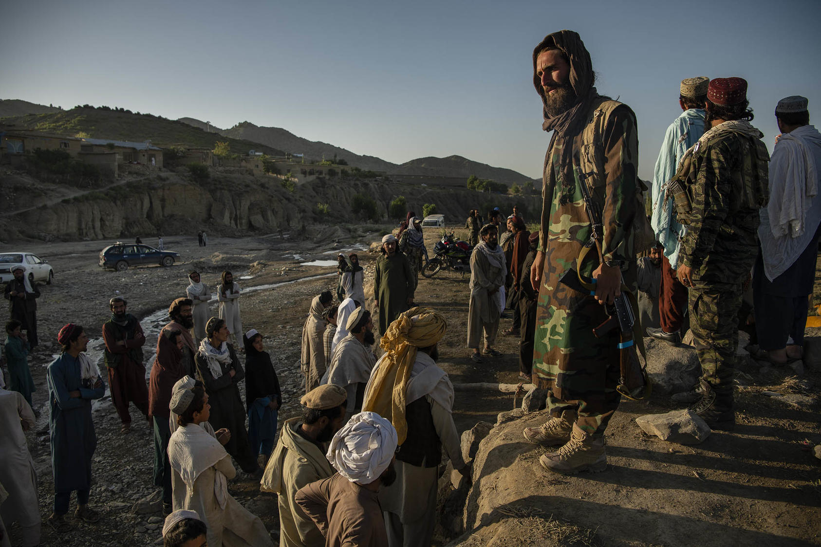 Taliban fighters guard an aid site and give instructions to survivors of the earthquake, in the Gayan district of Afghanistan, June 24, 2022. (Kiana Hayeri/The New York Times)