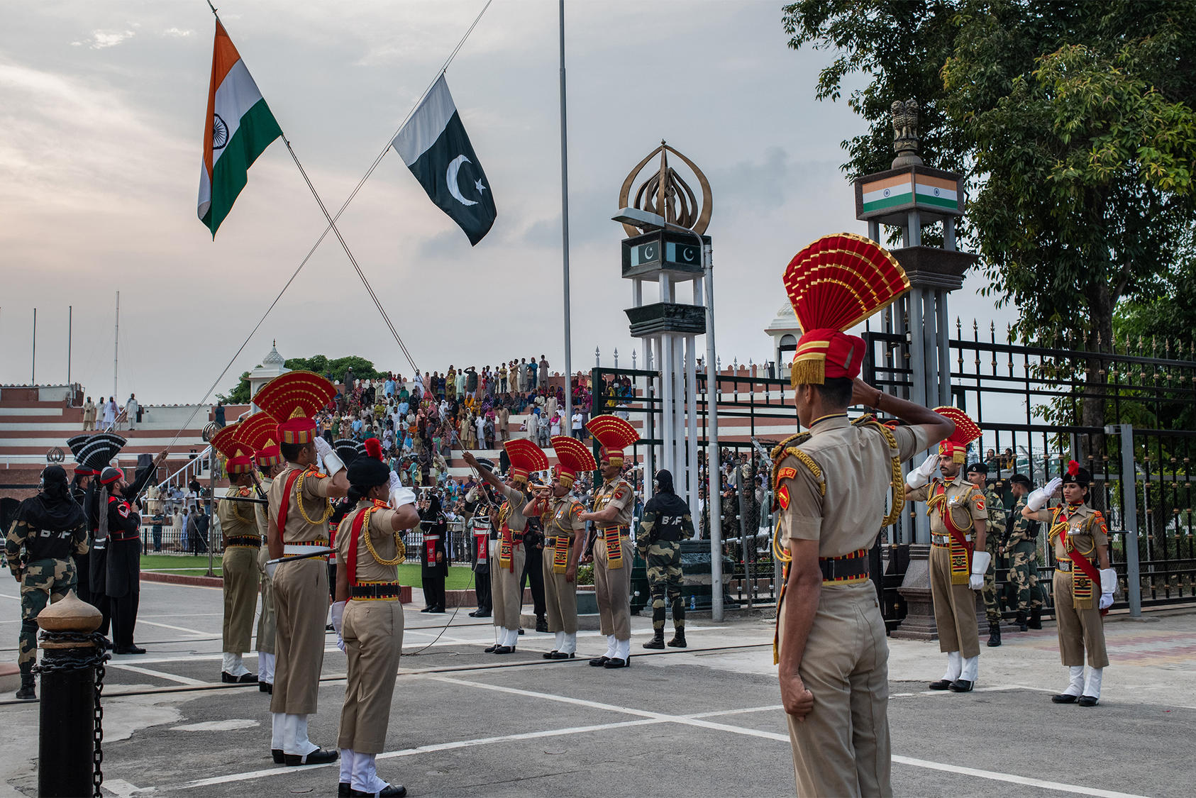 Members of India's Border Security Force, foreground, at the daily flag-lowering ceremony with their Pakistani counterparts, in black uniforms, at the Wagah-Attari border crossing, Sept. 19, 2019. (Rebecca Conway/The New York Times)