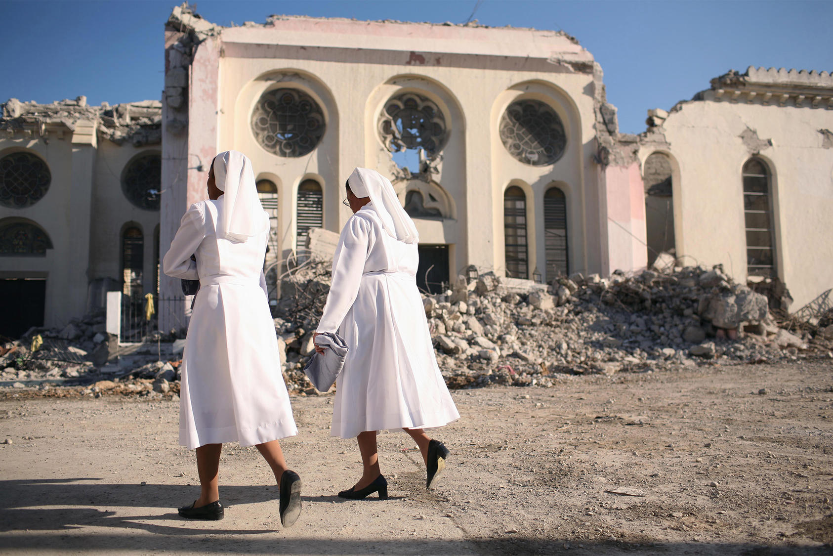 Nuns walk past the ruins of the national cathedral after an earthquake in Port-au-Prince, Haiti. Saturday, January 23, 2010. (Michael Appleton/The New York Times)