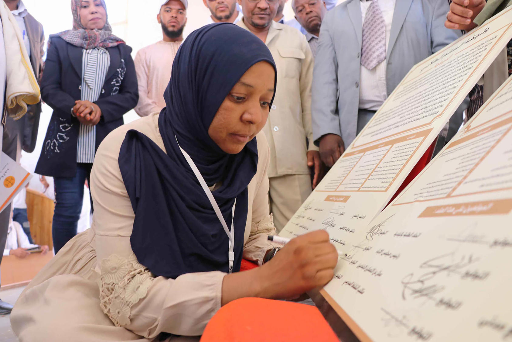 Aisha Abd Al-Nur signs a local social pact facilitated by USIP in Ubari, Libya. September 21, 2019. Libya has been named among the GFA’s priority countries.