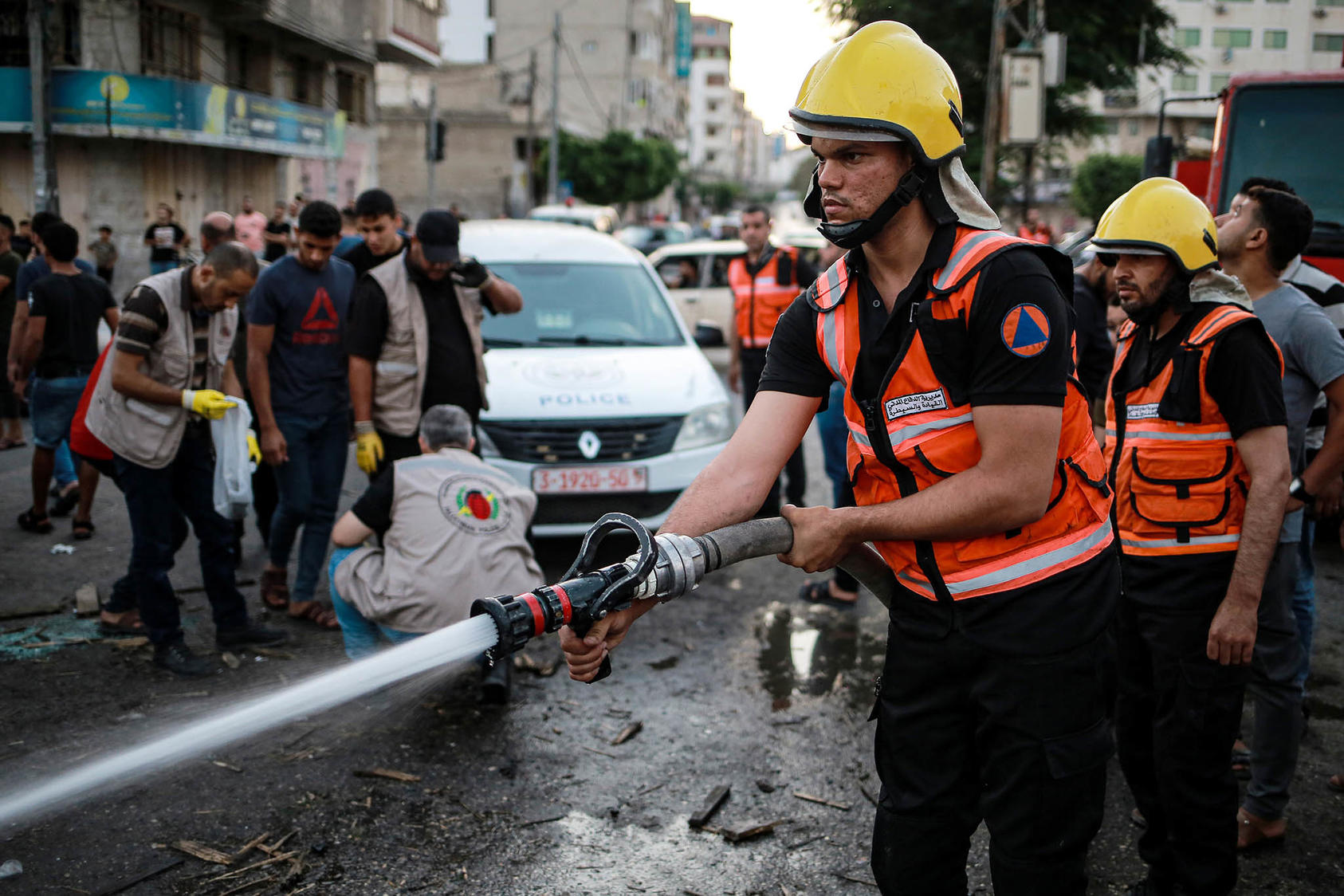 Civil defense workers in Gaza City clean up an area hit by an Israeli airstrike on Sunday, Aug. 7, 2022. (Hosam Salem/The New York Times)