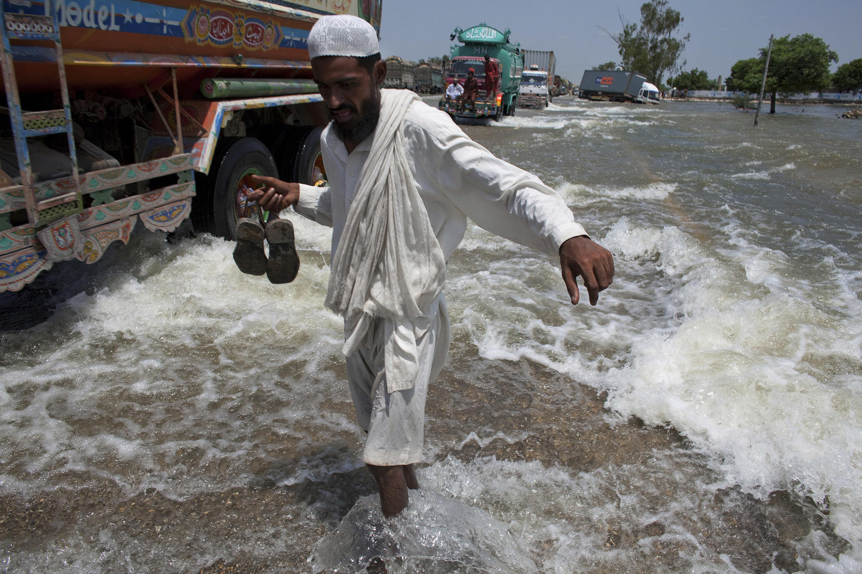 A Pakistani man walks across the main highway on the border of the Sindh and Punjab provinces of southern Pakistan, Aug. 22, 2010. With five million people displaced by flooding and with aid scarce, anger at the Pakistani government is growing. (Tyler Hicks/The New York Times)