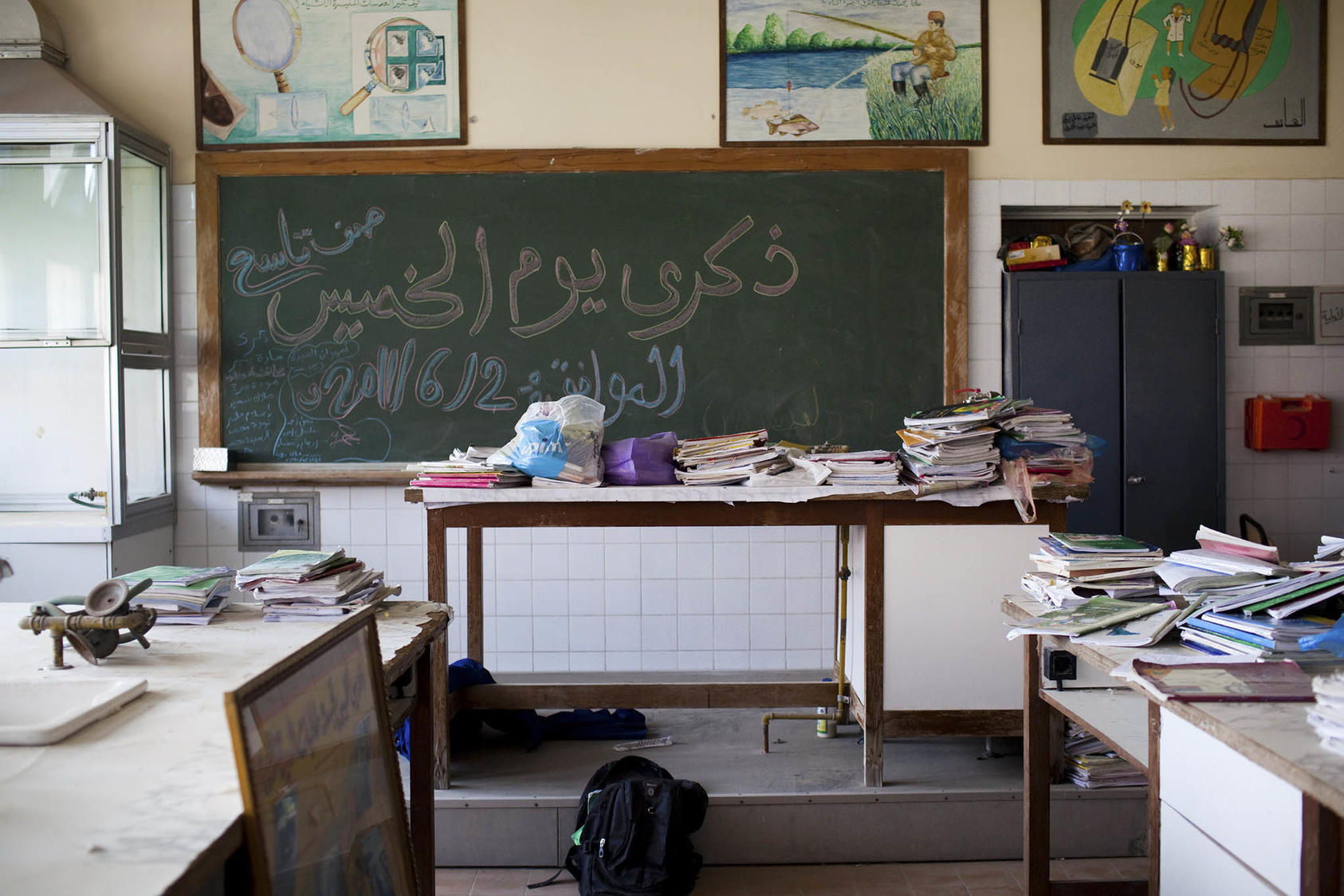 Books from the old Libyan curriculum are stacked up in an unused science laboratory at a school in Tripoli, Libya. October 2, 2011. (Nicole Tung/The New York Times)