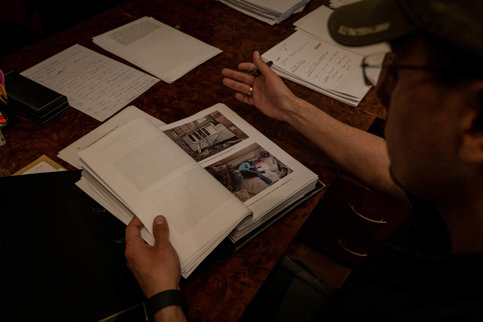 Police officer Andriy Andriychuk looks through files documenting potential war crimes, Kharkiv, Ukraine, May 2022. This year’s Nobel Peace Prize recognizes the role documenters play in holding governments accountable. (Nicole Tung/The New York Times)