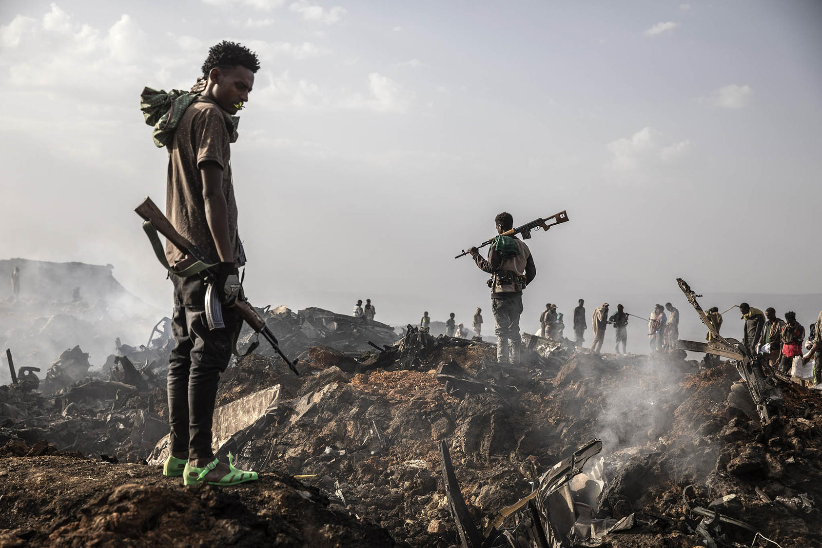 Tigray Defense Force fighters survey the wreckage of an Ethiopian Air Force plane downed in Mekelle, Ethiopia, June 23, 2021. (Finbarr O'Reilly/The New York Times)
