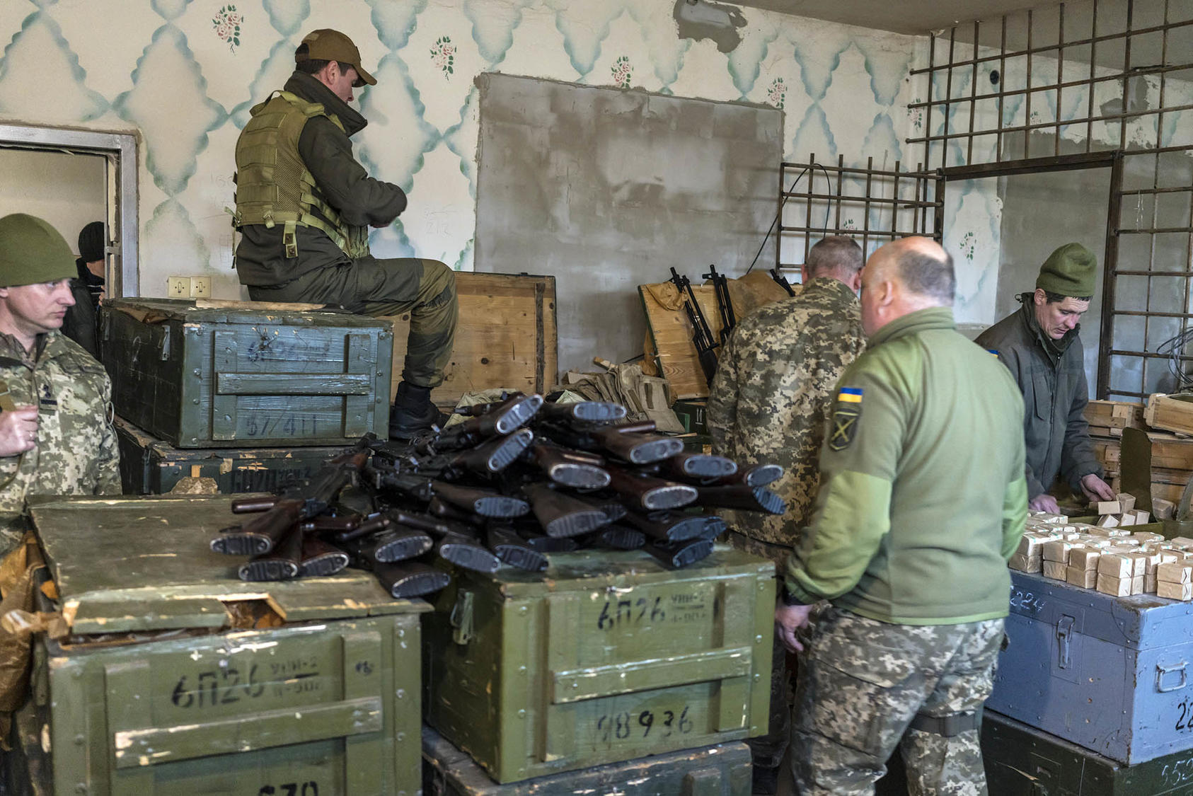 Military volunteers load magazines with ammunition on Feb. 25, 2022, at a weapons storage facility in Fastiv, Ukraine. war. (Brendan Hoffman/The New York Times)