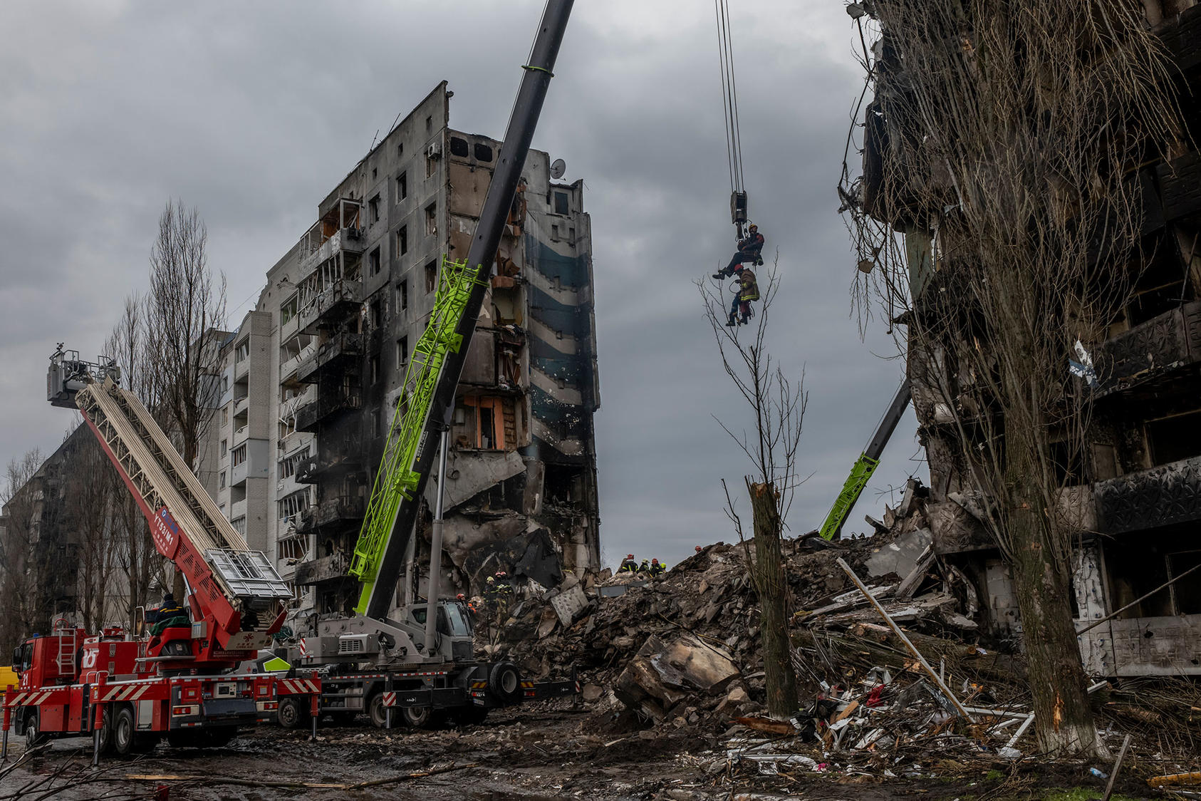 Rescue personnel use a crane to view inside the ruins of a bombed apartment building in Borodyanka, a town about 20 miles northwest of Kyiv, Ukraine on Saturday April 9, 2022. (Daniel Berehulak/The New York Times)