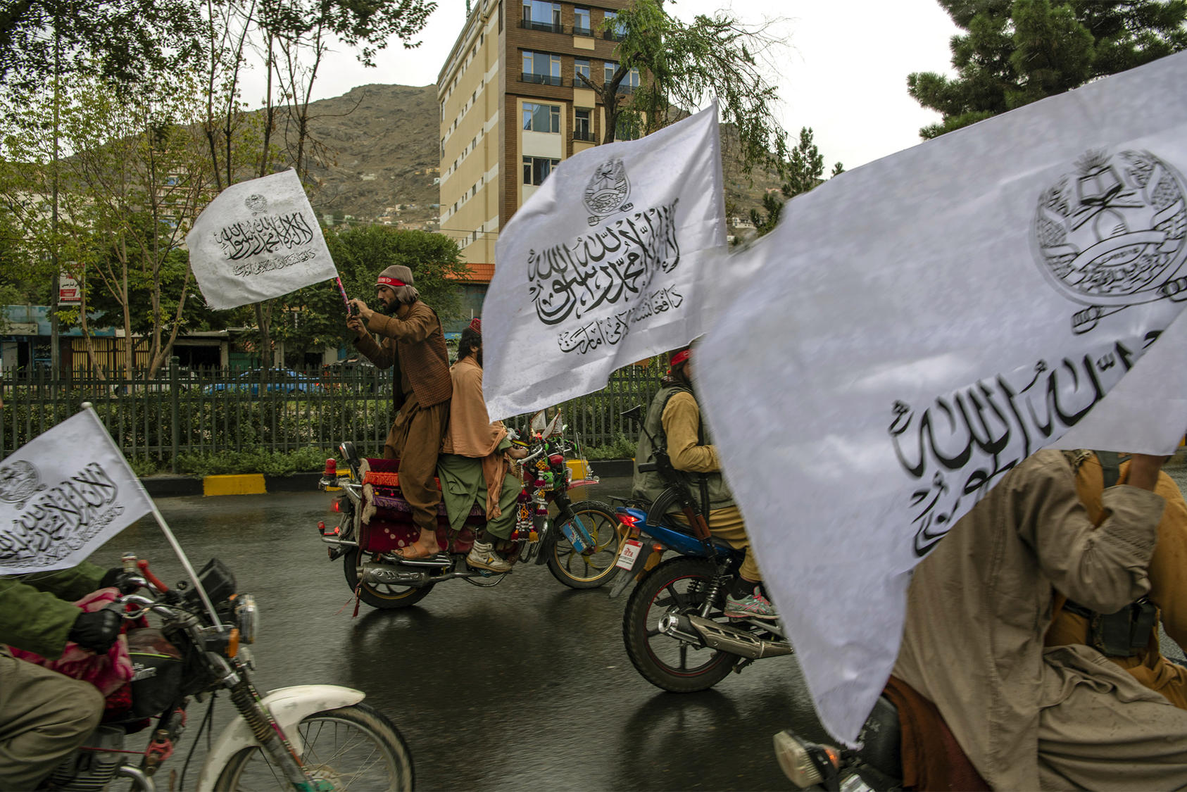 Taliban fighters, many of whom drove in from neighboring provinces, gather in Kabul to celebrate the first anniversary of their seizure of control over the capital on Monday, Aug. 15, 2022. (Kiana Hayeri/The New York Times)