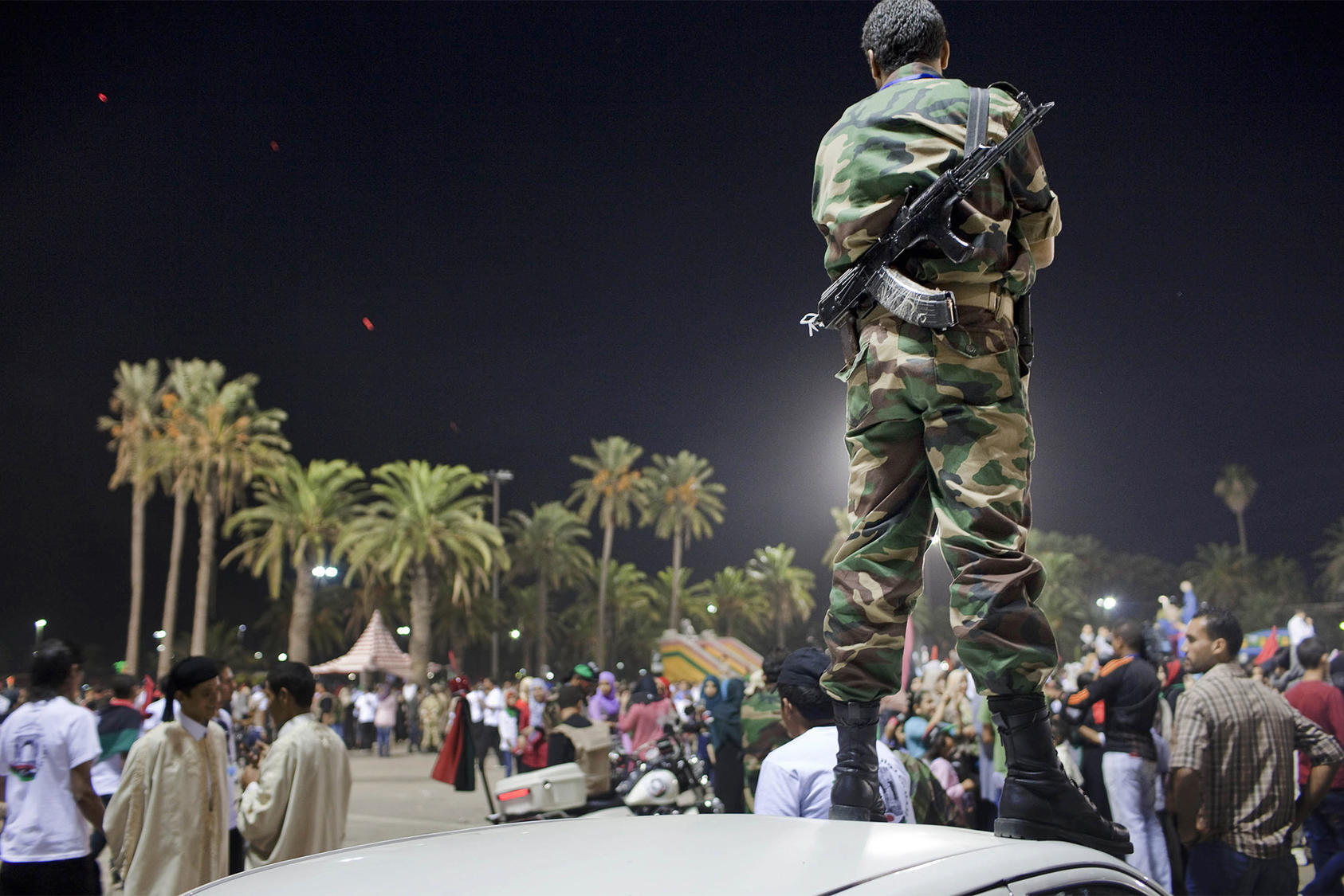 Libyans celebrate the fall of Muammar Qaddafi at Martyr's Square in Tripoli, Libya, Oct. 21, 2011. (Joao Pina/The New York Times)