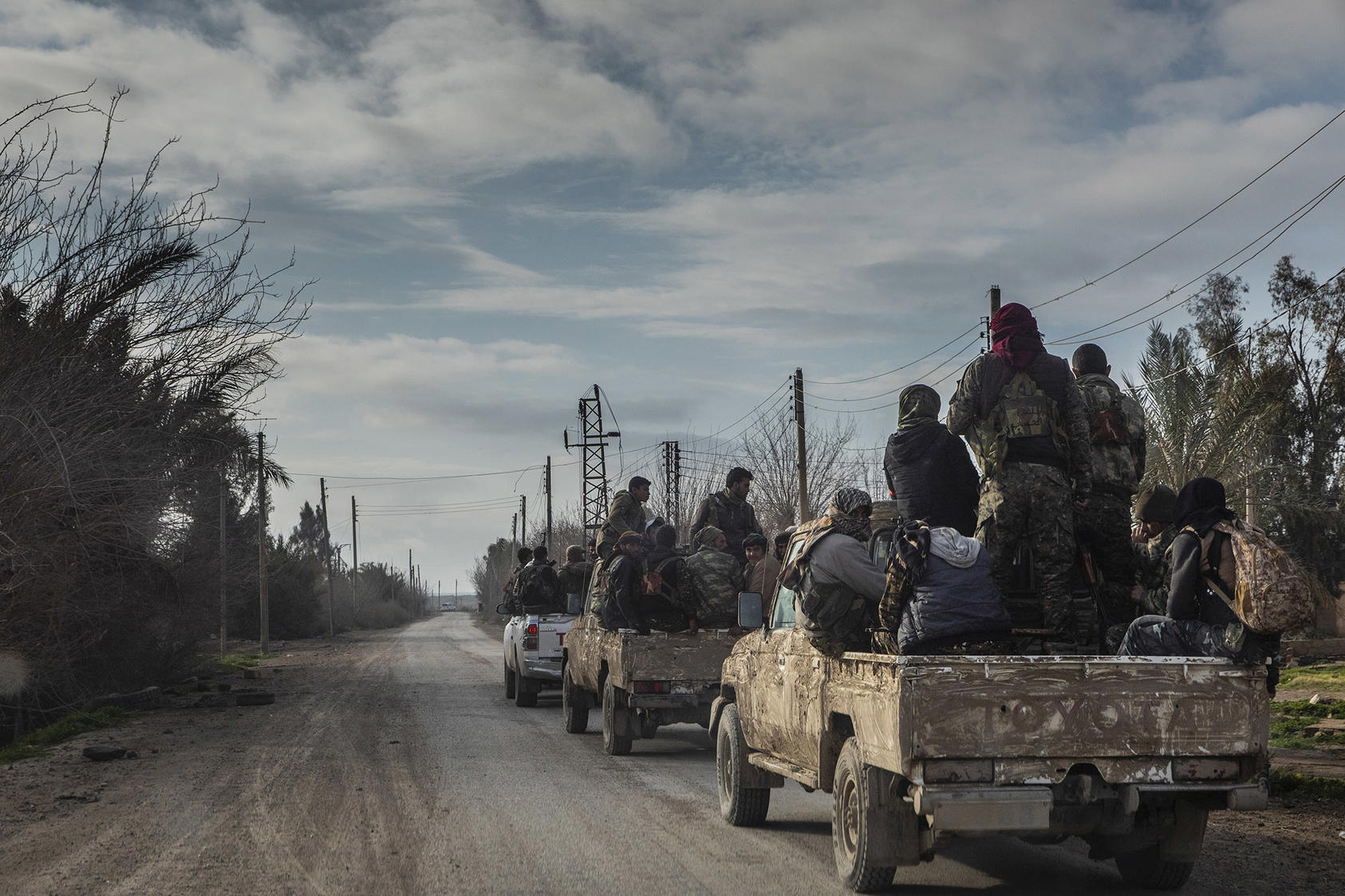 Fighters with the Syrian Democratic Forces head toward the front lines in the village of Baghuz, which was the last area controlled by the Islamic State group in Syria, on Feb. 11, 2019. (Ivor Prickett/The New York Times)
