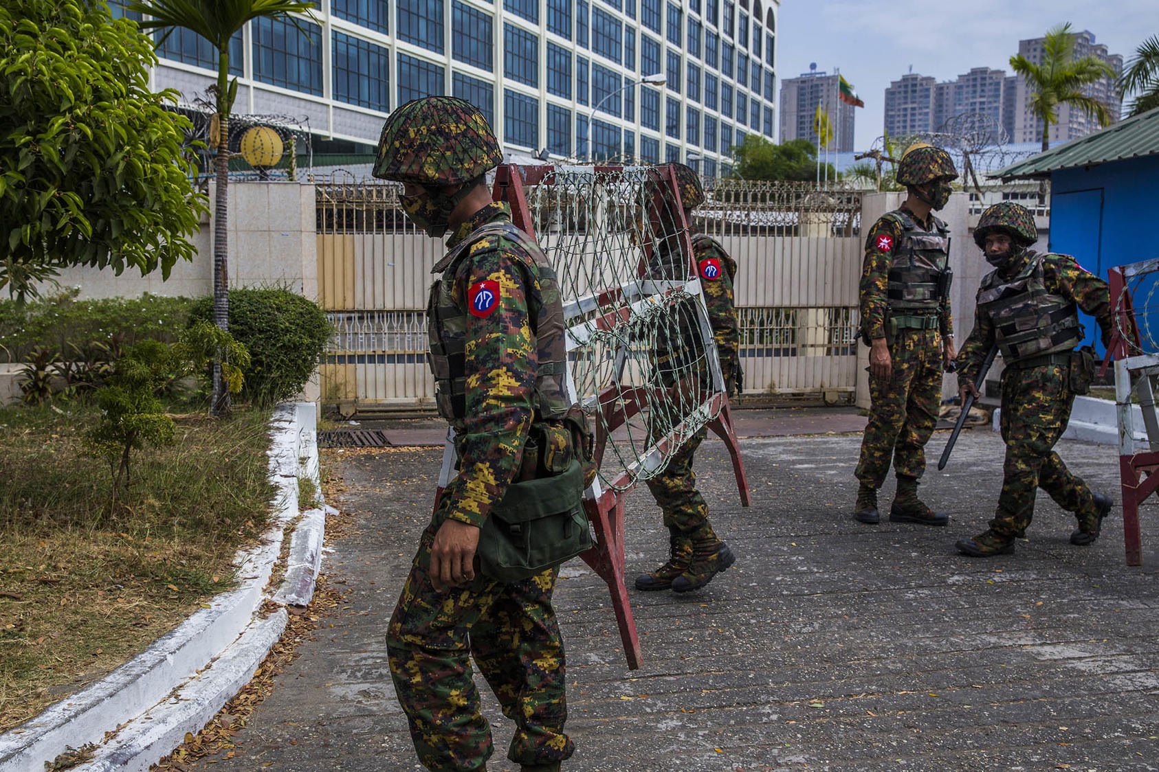 Soldiers set up barricades as tens of thousands of people gathered to protest the coup that ousted the civilian government in Yangon, Myanmar. February 15, 2021. (The New York Times)