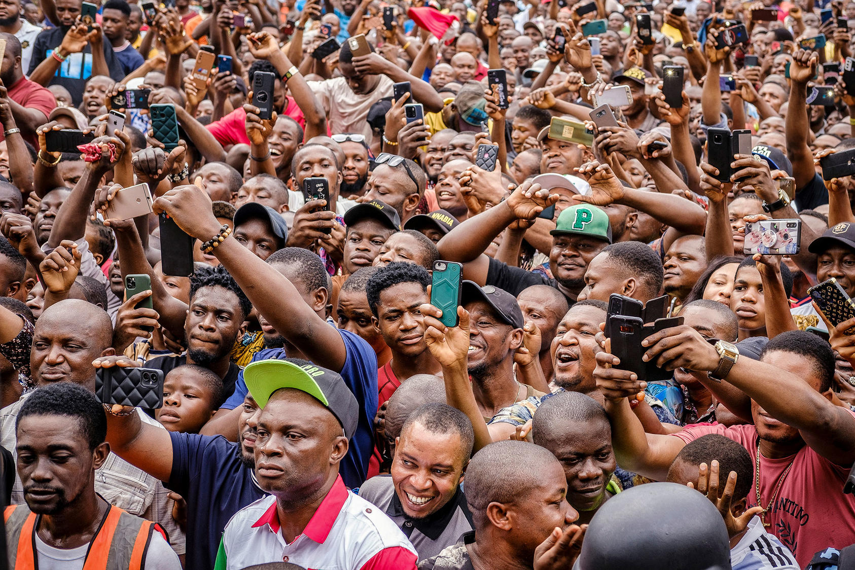 Nigerians in Lagos cheer and snap photos at a February rally for presidential candidate Peter Obi in a three-way race. Obi and rival candidate Atiku Abubakar are challenging the election’s declared outcome in court. (Taiwo Aina/The New York Times)