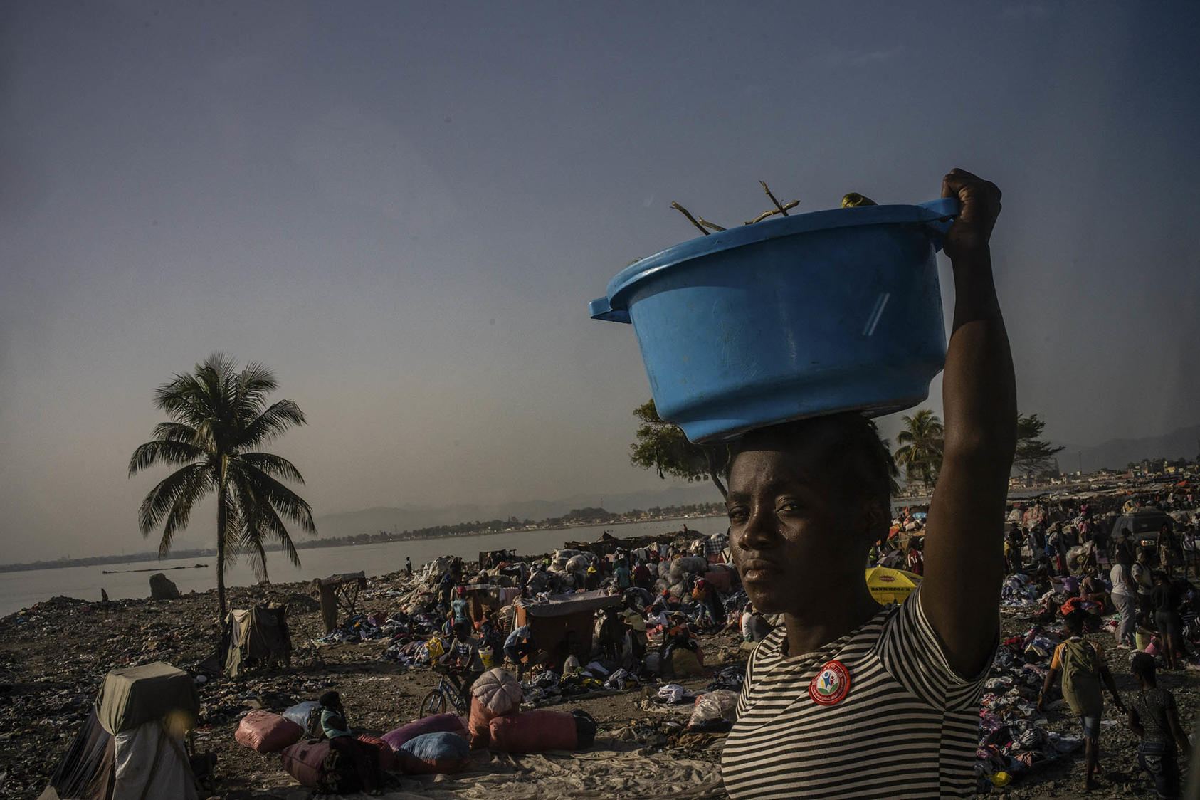People gather near the shore in Cap-Haitien, Haiti, on July 27, 2021. Haiti is one of the partner countries for the new U.S. approach to stabilization and conflict prevention. (Federico Rios/The New York Times)