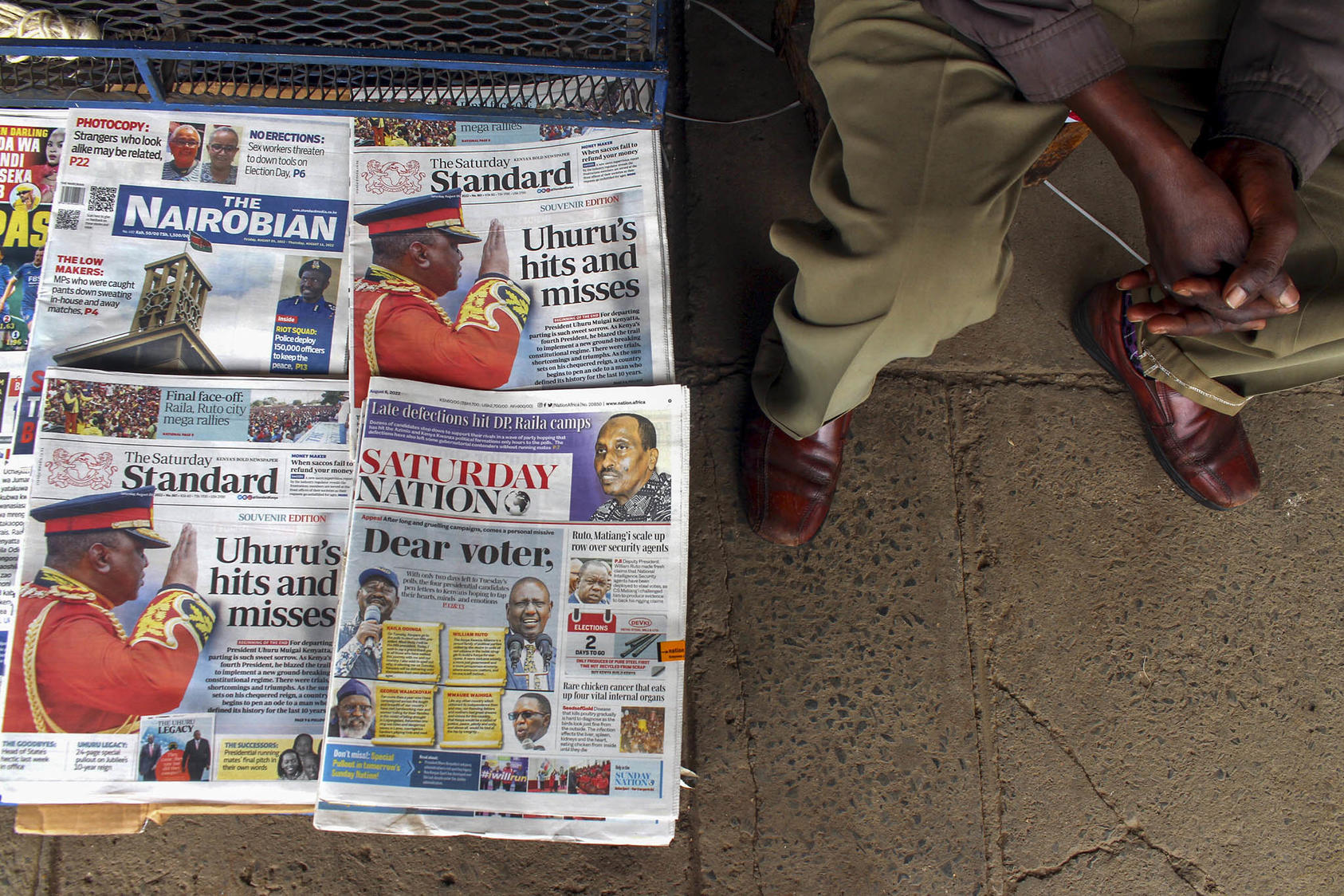 A vendor sits by the newspapers he is selling on a street in downtown Nairobi, Kenya, on August 6, 2022, three days before the country’s general election. (Photo by AP)
