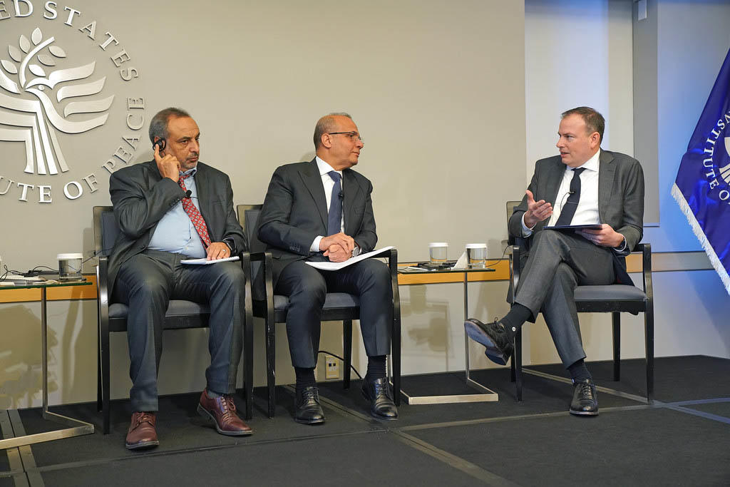 From left to right: Muftah Nasib, a member of Libya’s National Planning Council member and Abdullah Al-Lafi, deputy head of the Libyan Presidential Council, in conversation with USIP’s Thomas Hill while at USIP.