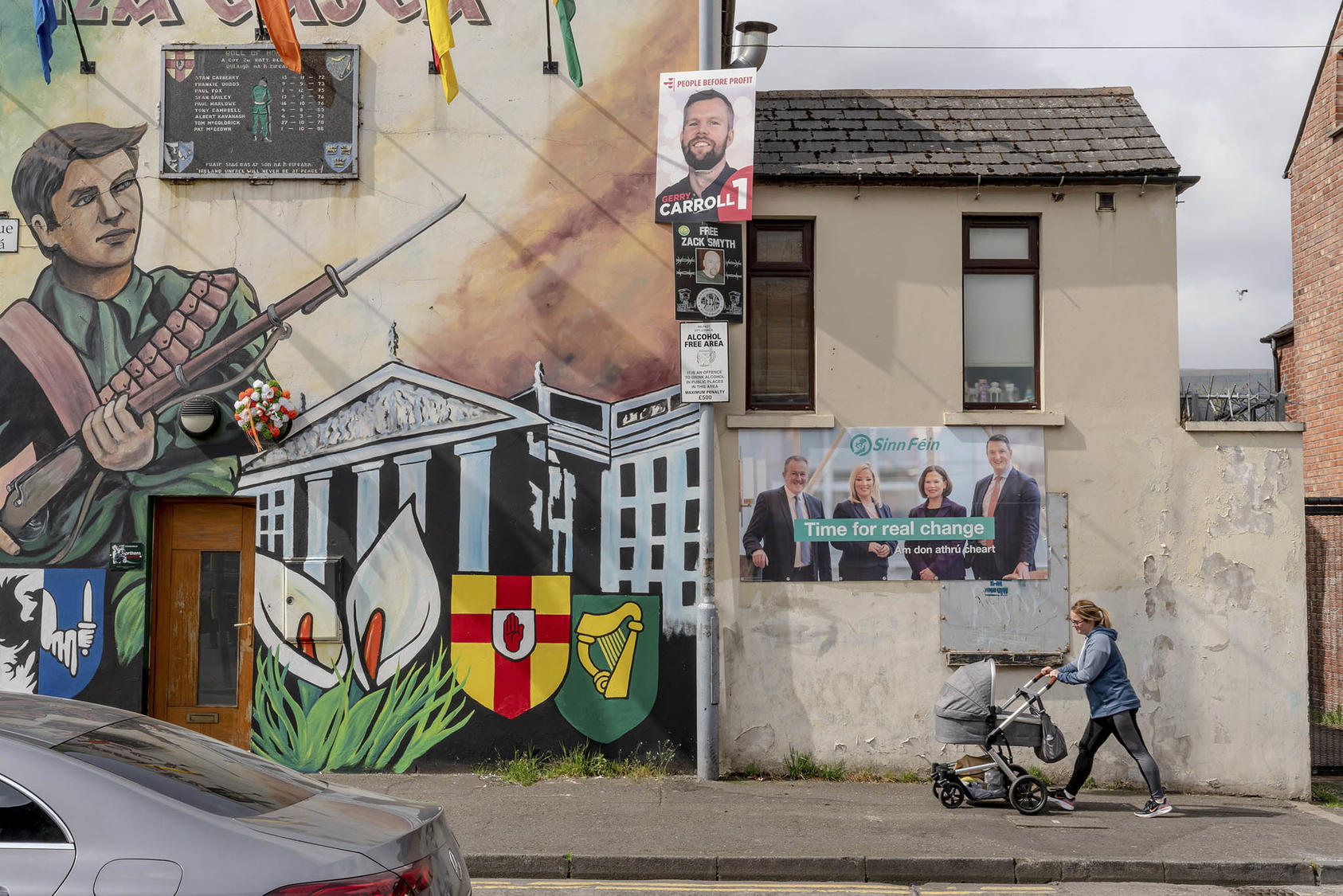 A Belfast mural and election posters from 2022 reflect how Northern Ireland’s 1998 peace accord converted warfare back into political contest. (Andrew Testa/The New York Times)