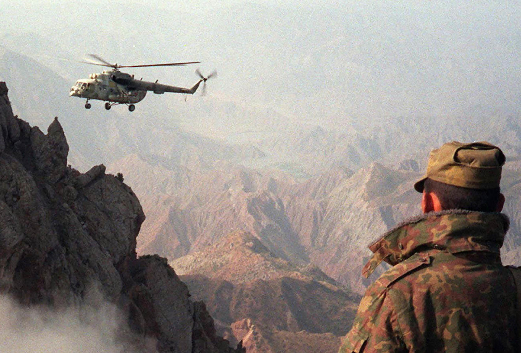 A helicopter brings supplies to Russian border guards during the Tajik civil war on August 1, 1996. (Photo by AP)