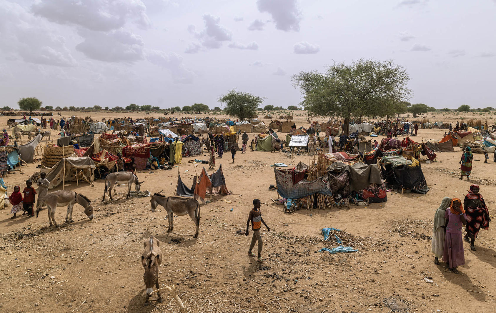 Sudanese who fled their country’s latest violence camp just over the border in Koufroune, Chad. Sudan’s new warfare has forced tens of thousands to flee into neighboring countries that are riven by their own violence. (Yagazie Emezi/The New York Times)